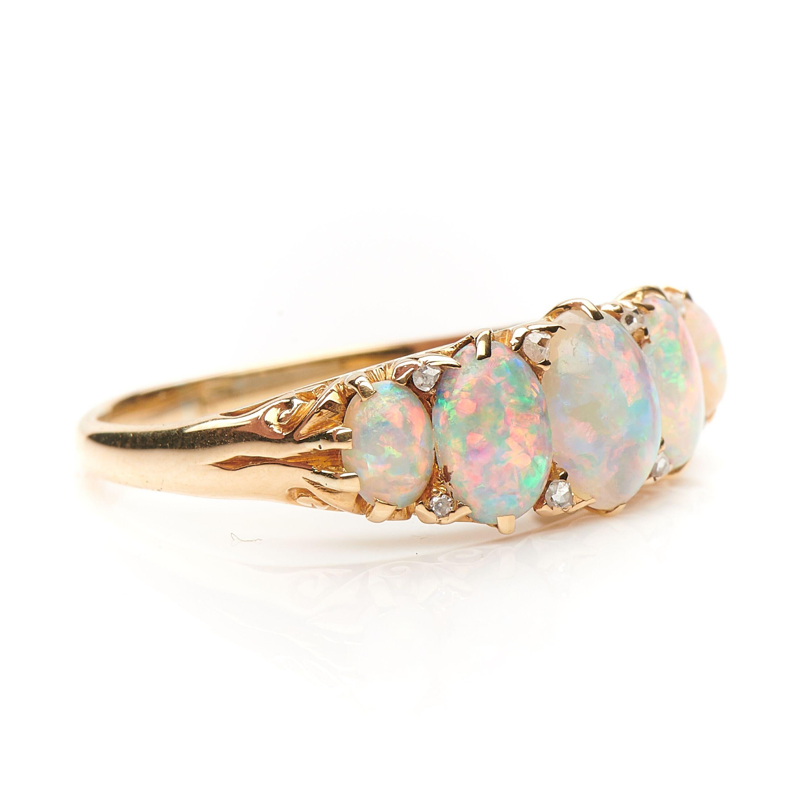 Victorian, opal and diamond carved half hoop ring. Set with five incredible opals with a exceptional range of colour - the photographs do not do this ring justice! Interspersed with little diamonds. The setting is beautifully carved from 18ct gold