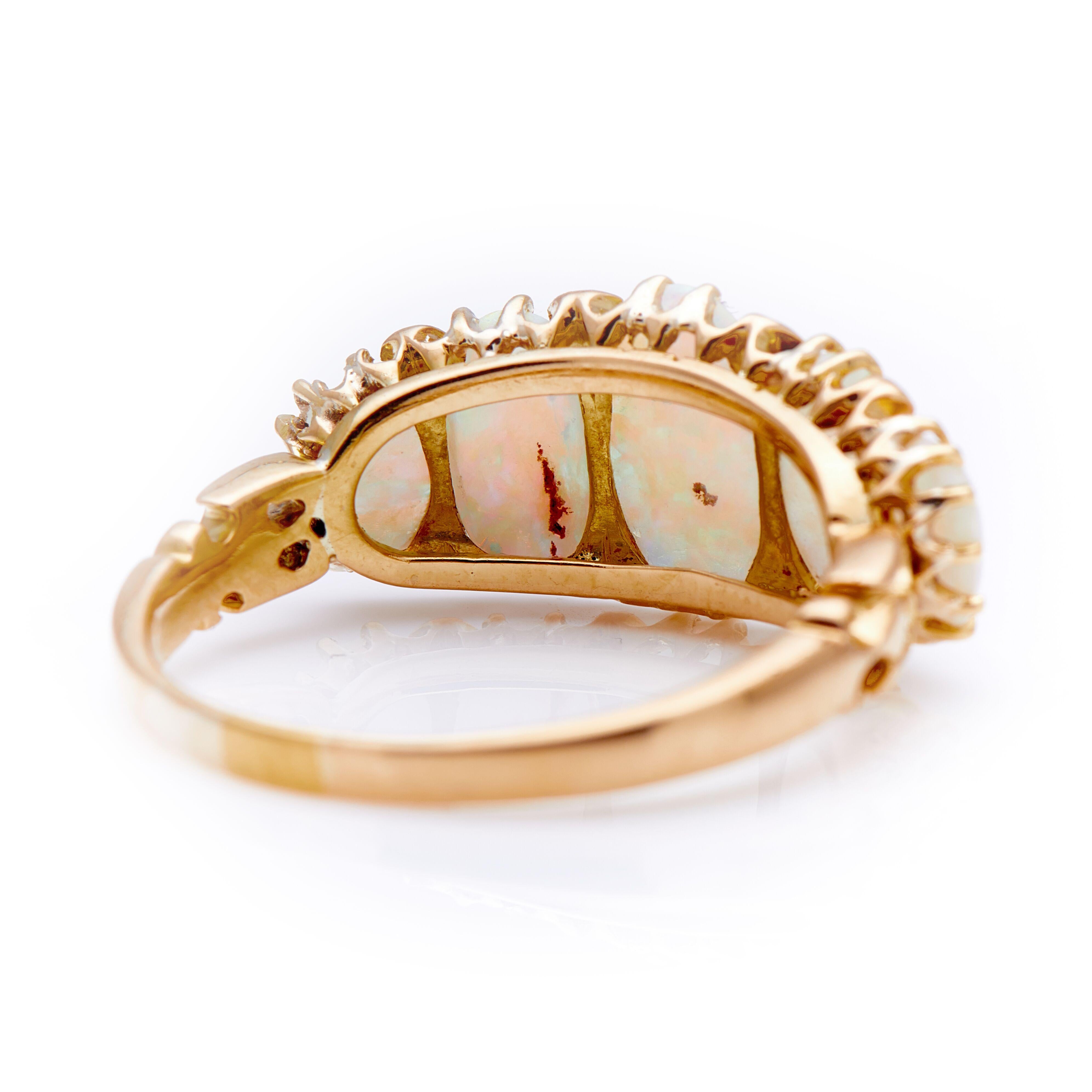 Victorian, opal and diamond half hoop ring, circa 1880. Set with five graduating opals displaying an intense palette of alluring colours resembling a texture of a painting. Each natural opal is interspersed with tiny diamond points to add a touch of