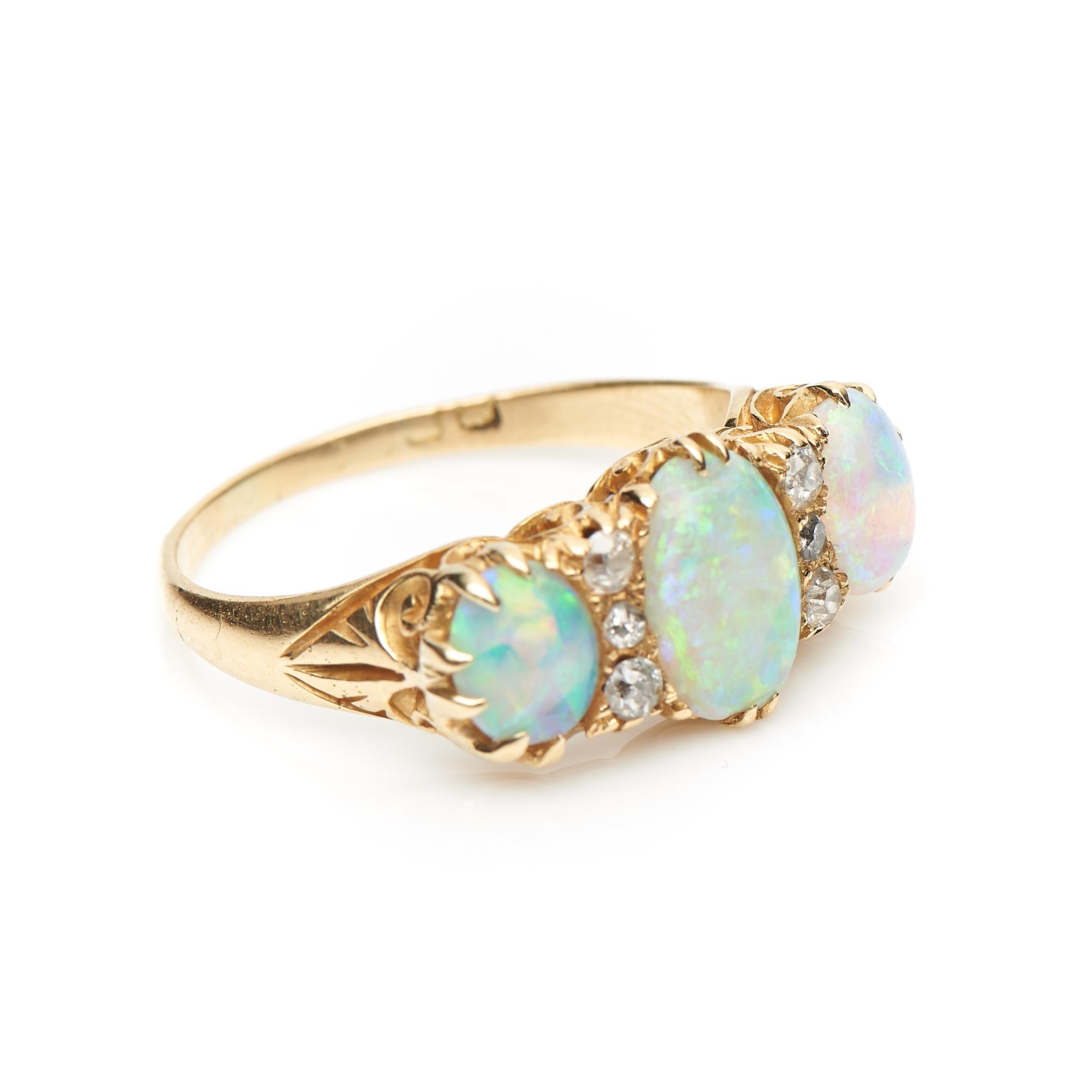 Victorian, triple opal and diamond cocktail ring, circa 1900. Horizontally set with three magical electric blue coloured opals interspersed with old-cut diamonds set in an intricately carved ornate gallery which has a beautiful scrolling design. The