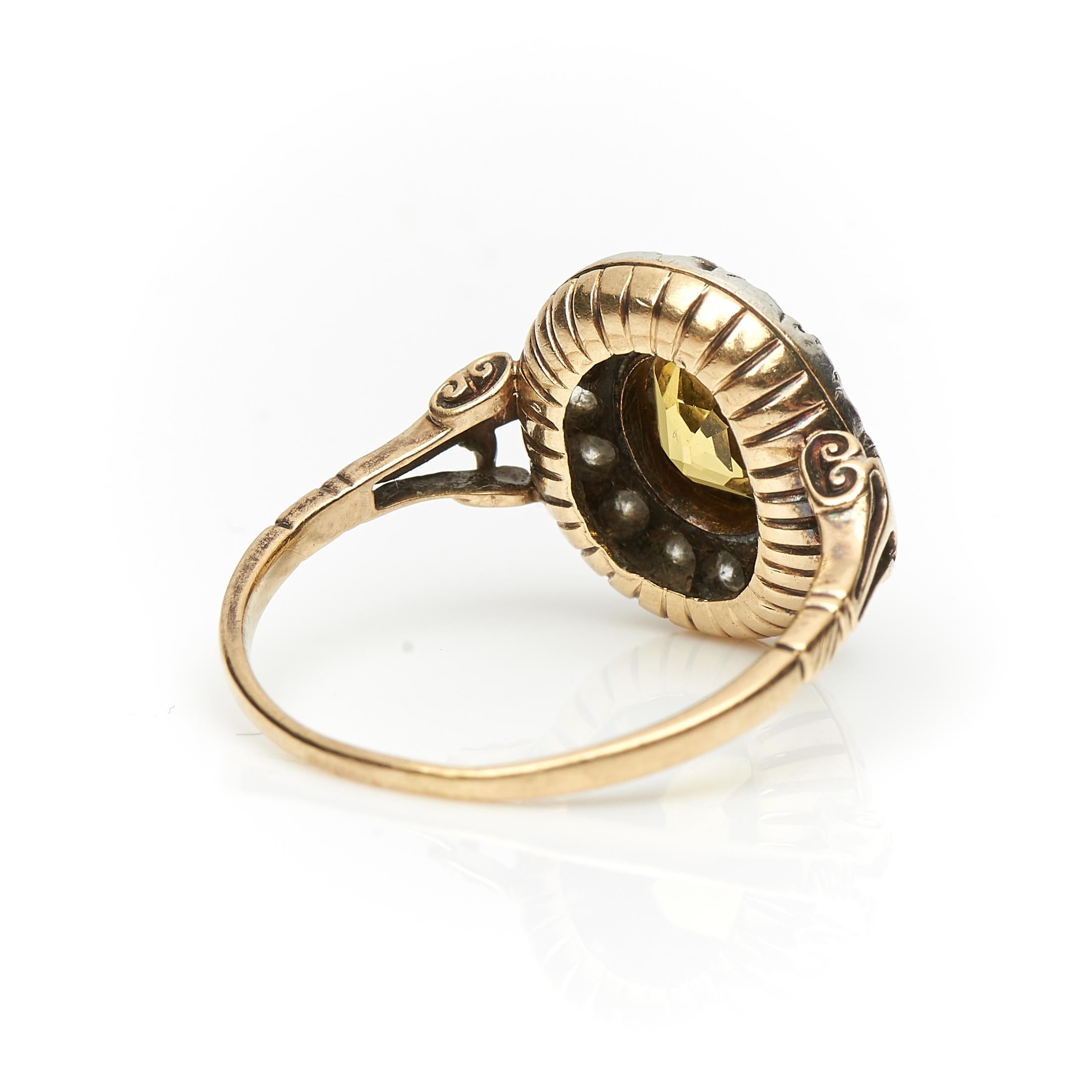 An incredible, 19th century, natural yellow (golden coloured) sapphire and diamond ring, circa 1860. Set to centre a vibrant certified untreated round-cut yellow sapphire encircled by sparkling old-cut diamonds, all set in crimpled style collet