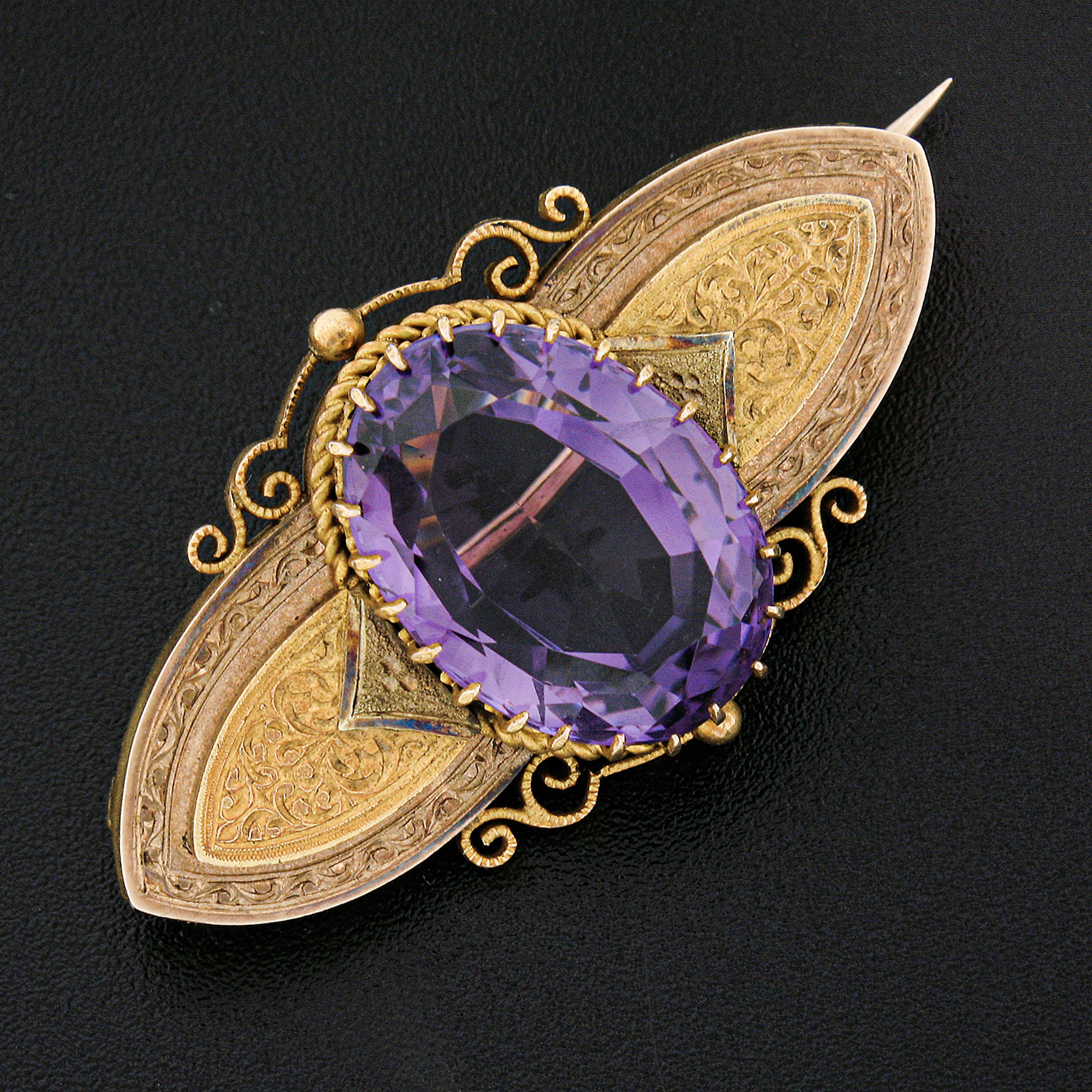 Here we have an outstanding antique brooch that was crafted from solid 18k yellow gold during the Victorian era. The brooch features a magnificent natural amethyst stone that has an oval brilliant cut and is neatly multi-prong set at its center,