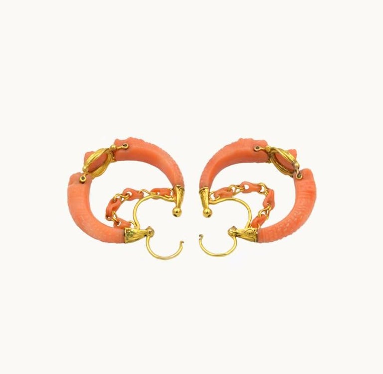 Antique Victorian 18 karat yellow gold hoop earrings from circa 1850s.  These incredible and unique earrings feature coral carved with a lion and flower motif!

These earrings measure approximately 1.37 inches in length across the earring, 1.54