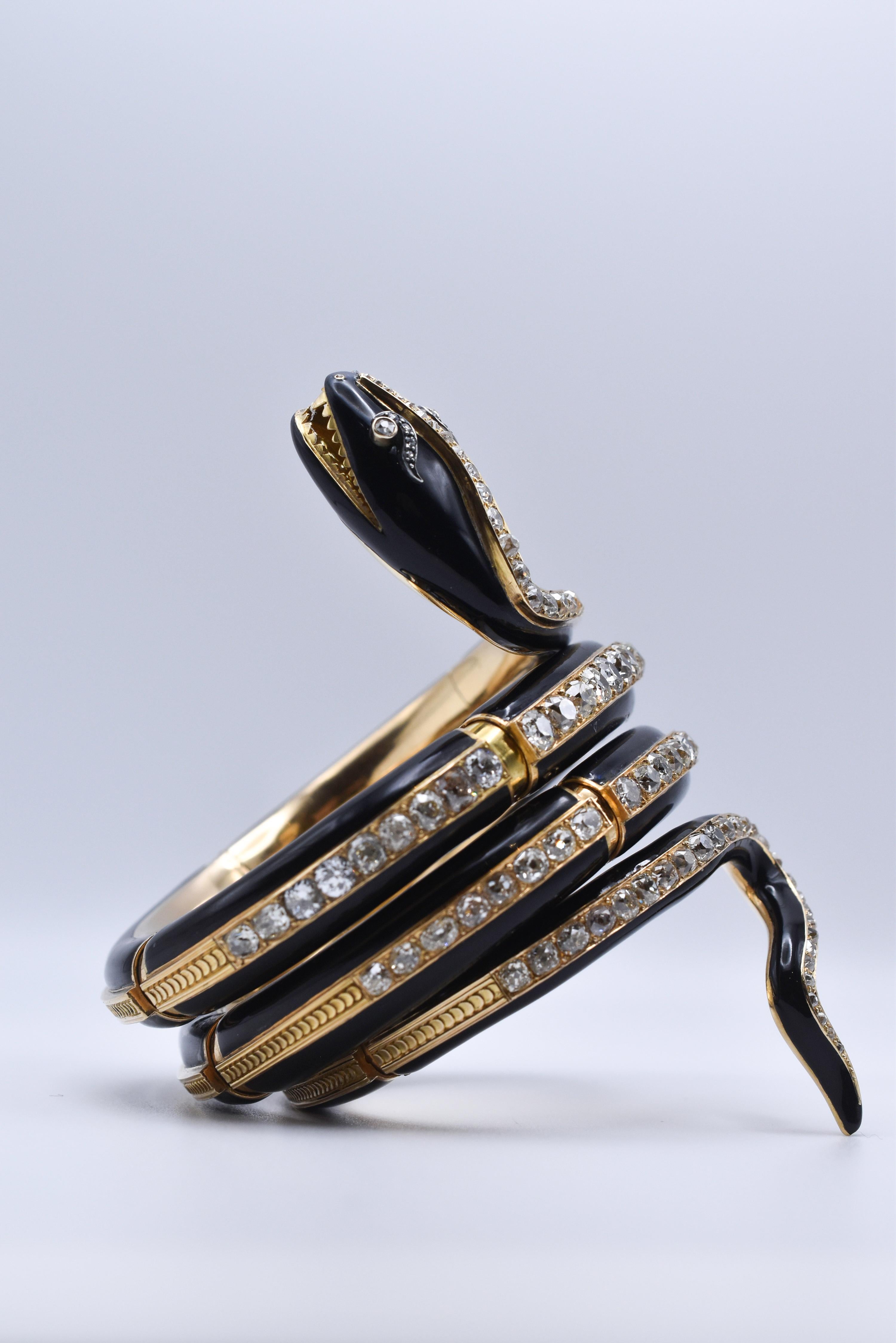 A fine Antique Snake Bracelet dating back to the Victorian era, crafted in 18k yellow gold with black enamel design, showcasing 28 carats of Old Mine Cut Diamonds. Made in Italy, circa 1880.
