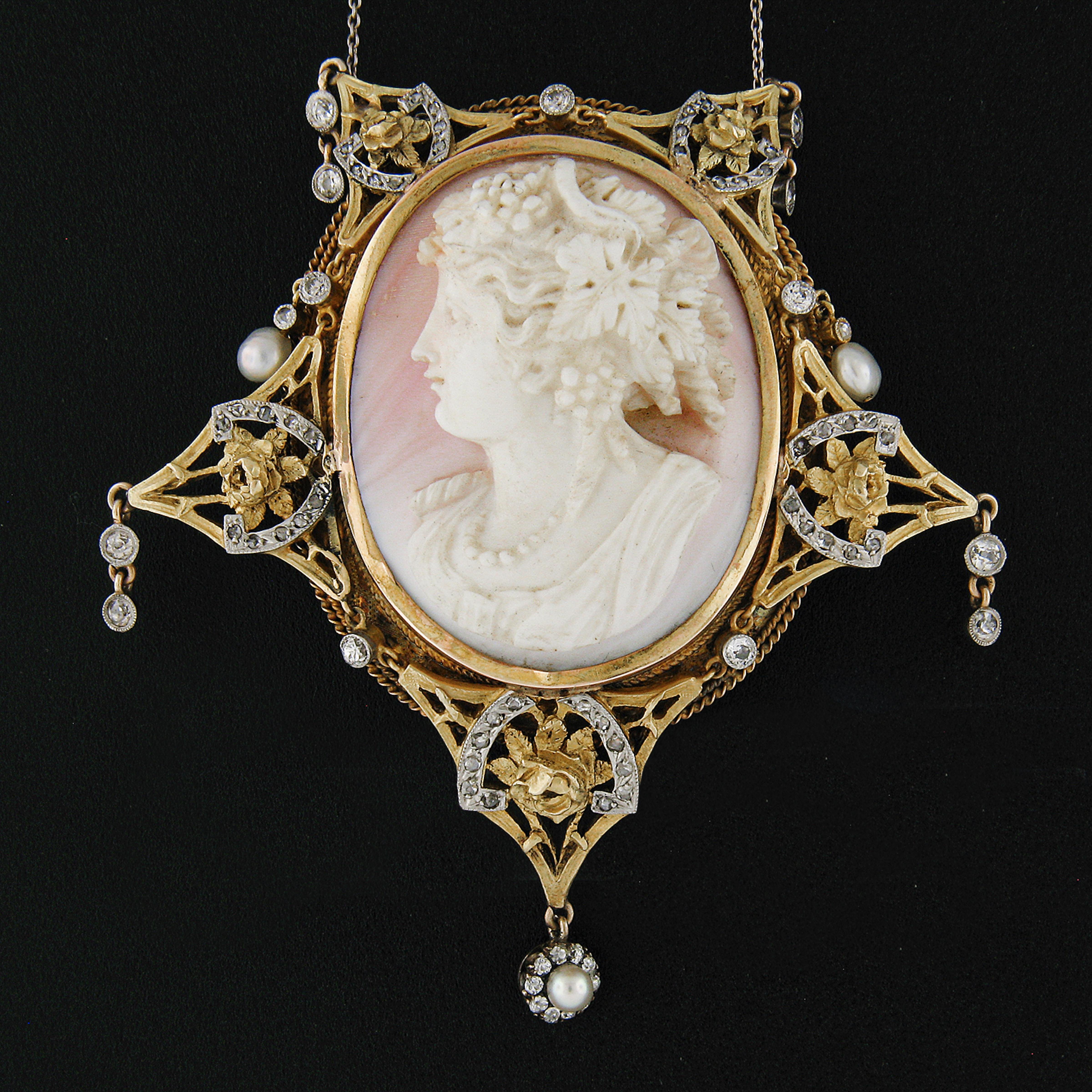 This magnificent antique brooch was crafted from solid 18k yellow gold during the Victorian era. It features a VERY DETAILED, oval shaped, high relief cameo carved from a natural white and pink shell that was then bezel set at its center. The cameo