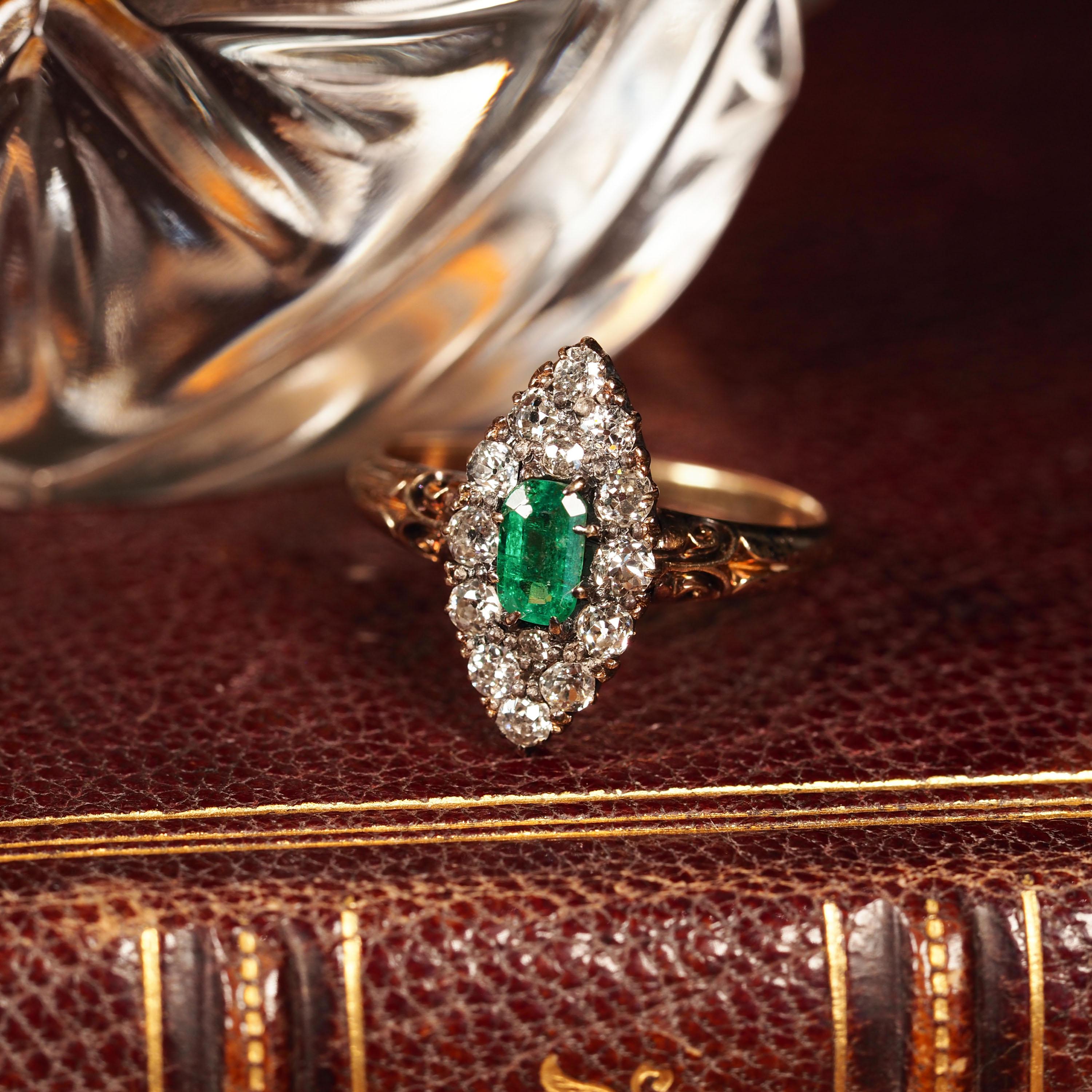 We are delighted to offer this superb Victorian 18ct gold ring with an intricate navette design made c.1880. 
 
Distinctly Victorian and distinguished from contemporary pieces, this gorgeous piece presents one central 'emerald-cut' emerald