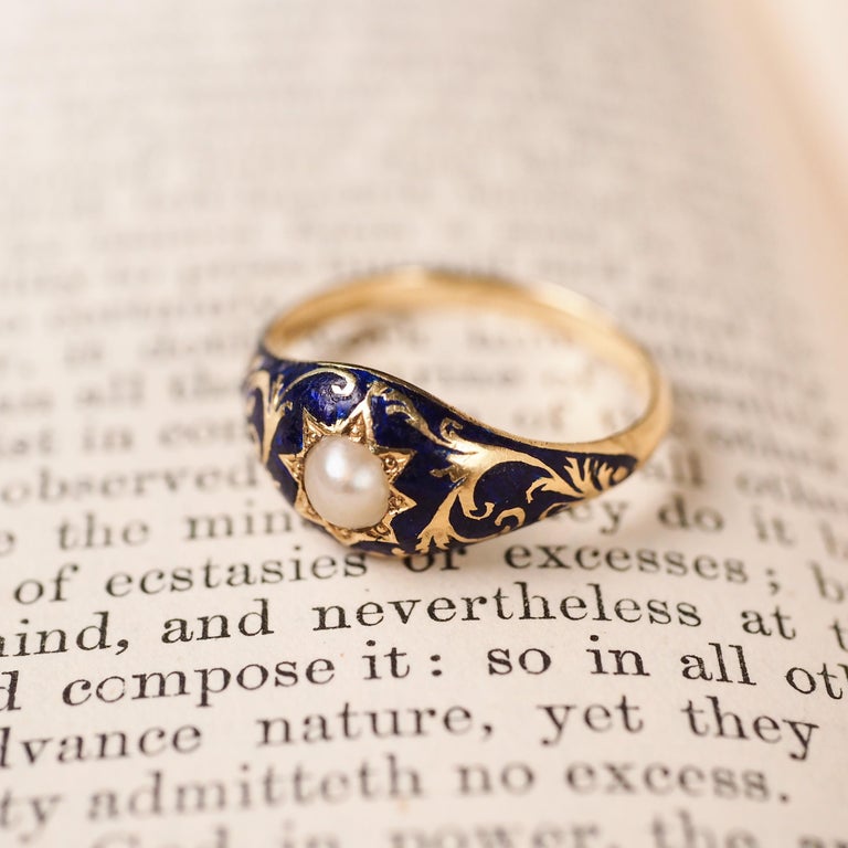 We are delighted to offer this fabulous Victorian 18K gold antique enamel ring.

The ring features a gorgeous gold engraved design of acanthus leaves contrasted by a deep blue enamel that covers the top section of the ring. 

A pearl is present in