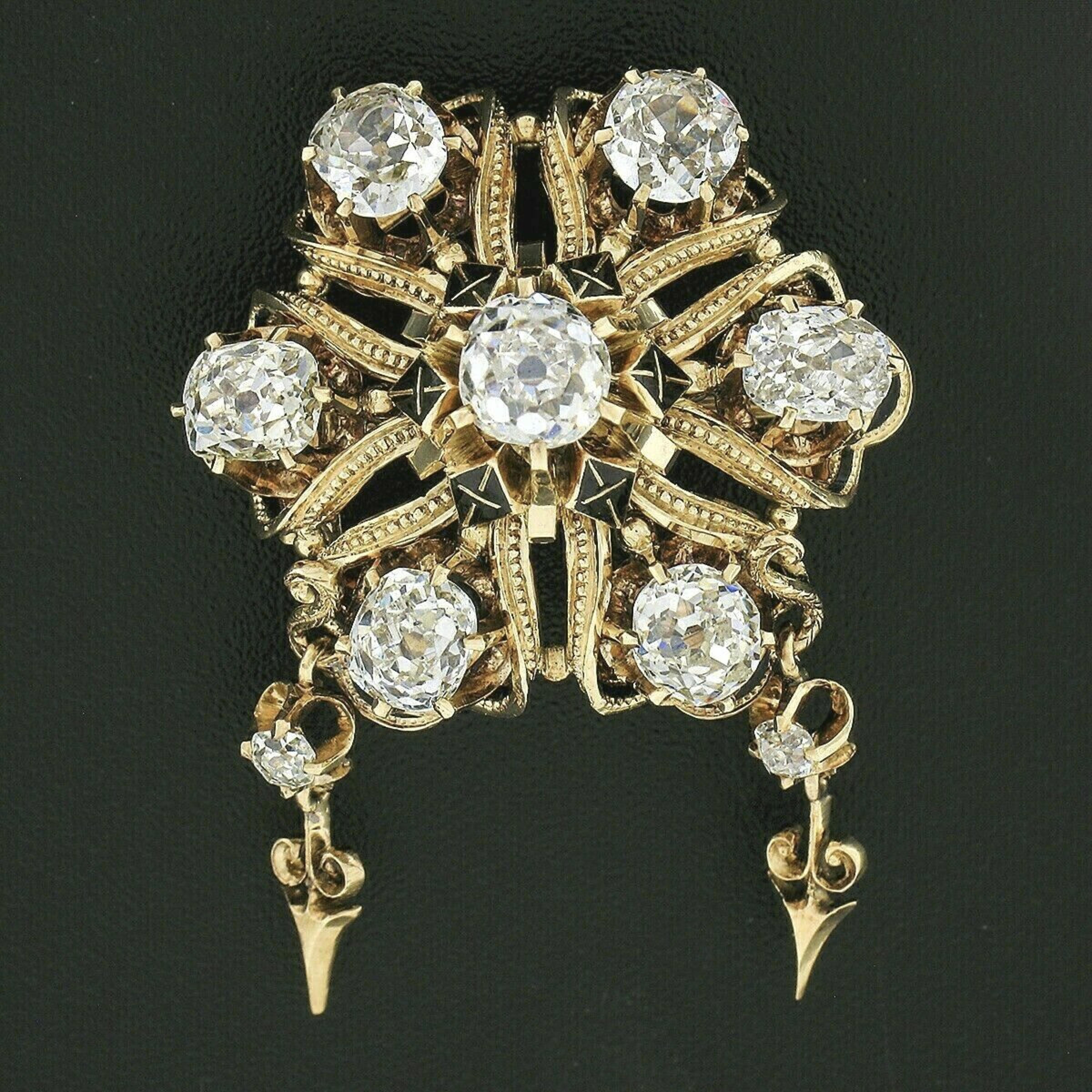 This is an absolutely breathtaking antique brooch that was crafted in solid 18k yellow gold during the Victorian era and features a gorgeous open work flower design that is set with fine quality diamonds throughout. The seven stunning diamonds at