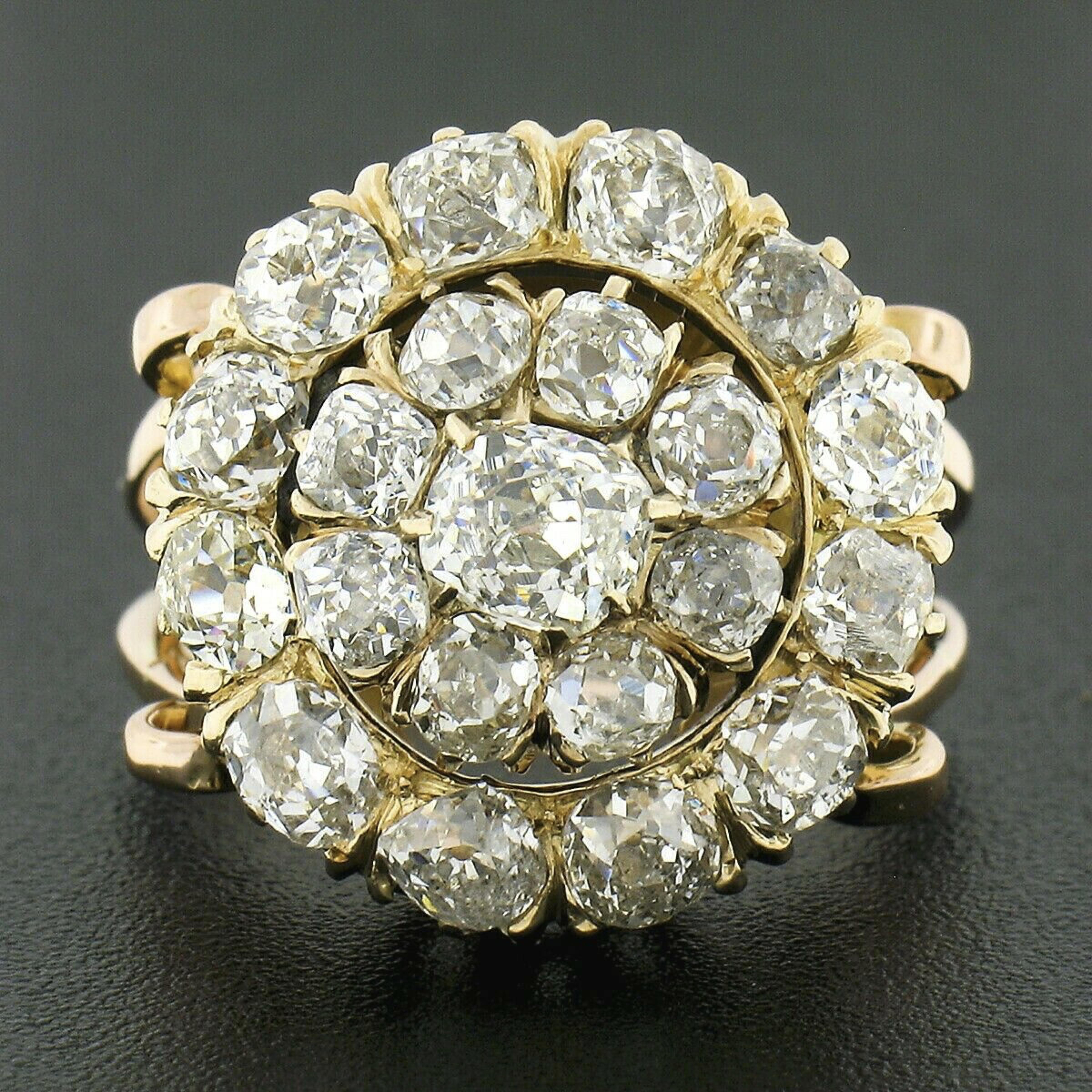 This truly breathtaking antique diamond ring is crafted from solid 18k rose and yellow gold during the Victorian period and features a platter style with a stunning cluster of chunky old mine cut diamonds throughout its top. These fine diamonds are