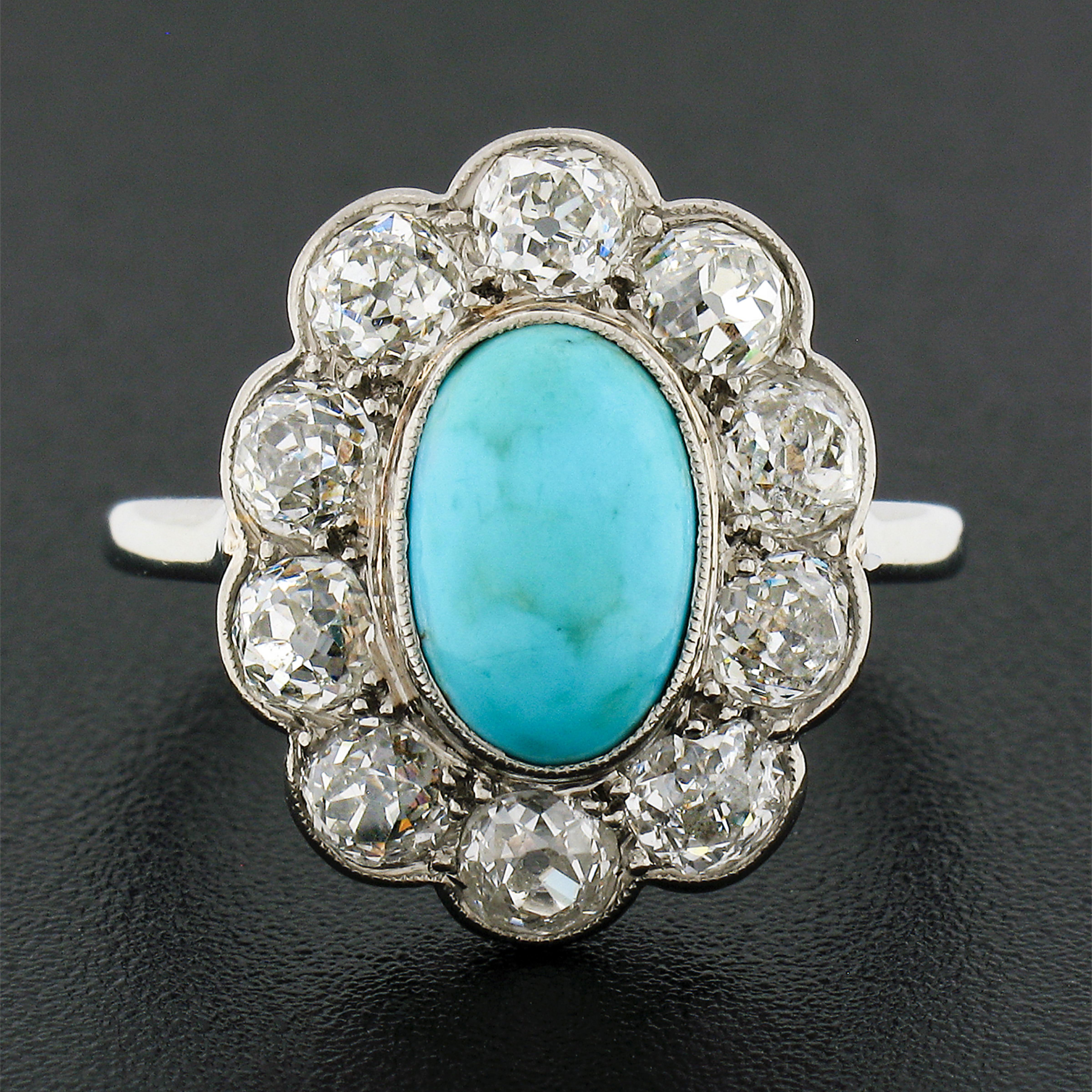 This absolutely gorgeous antique ring was crafted during the late Victorian/Edwardian era in solid 18k white gold and features a beautiful natural  turquoise stone neatly bezel set at the center of a super lively old mine cut diamond halo. The fine