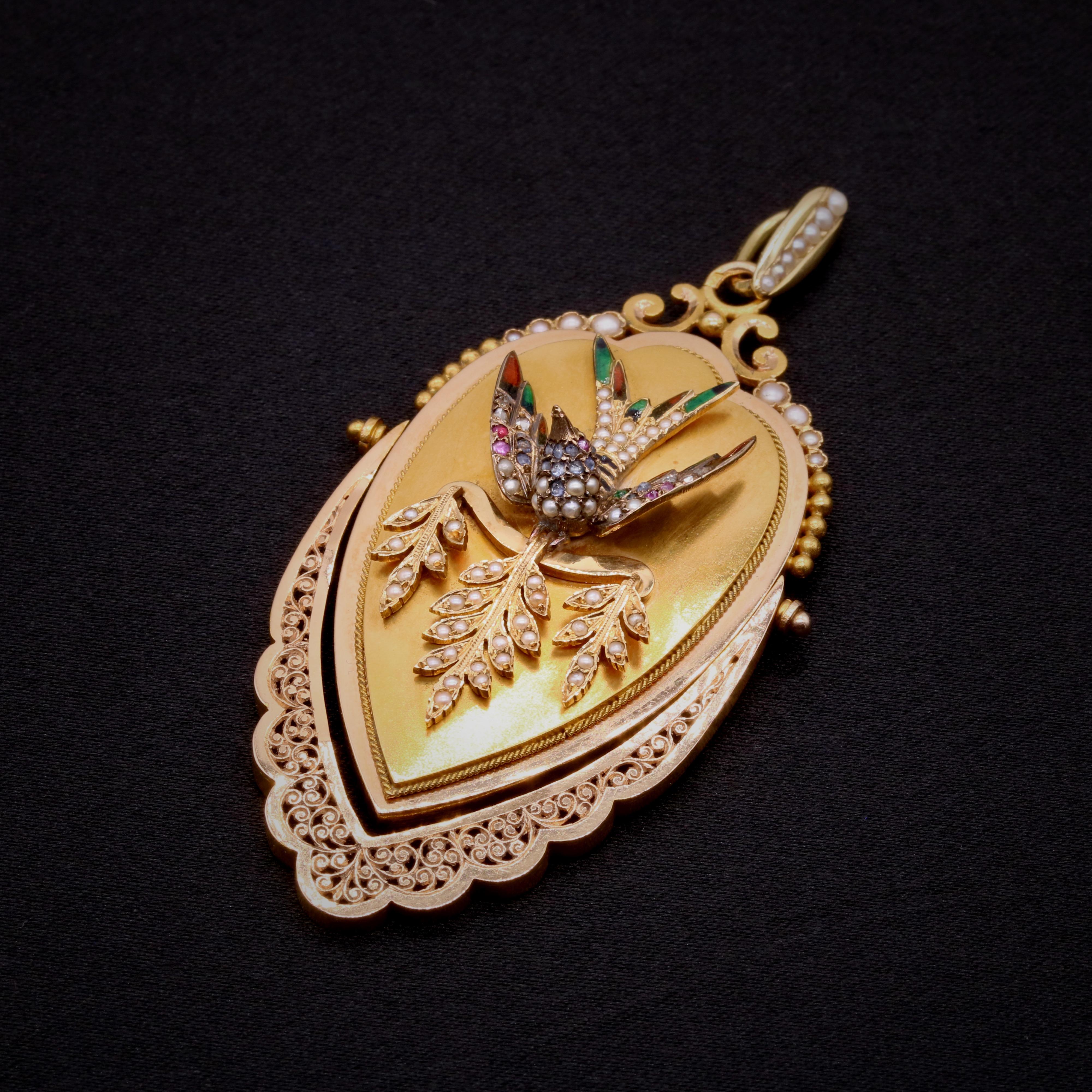 A Victorian pearl, diamond, sapphire, ruby, enamel, and yellow and rose gold locket pendant, comprising seventy-five half seed pearls, 1 whole seed pearl, six round cut rubies, six rose cut diamonds, sixteen round cut sapphires, and multicoloured