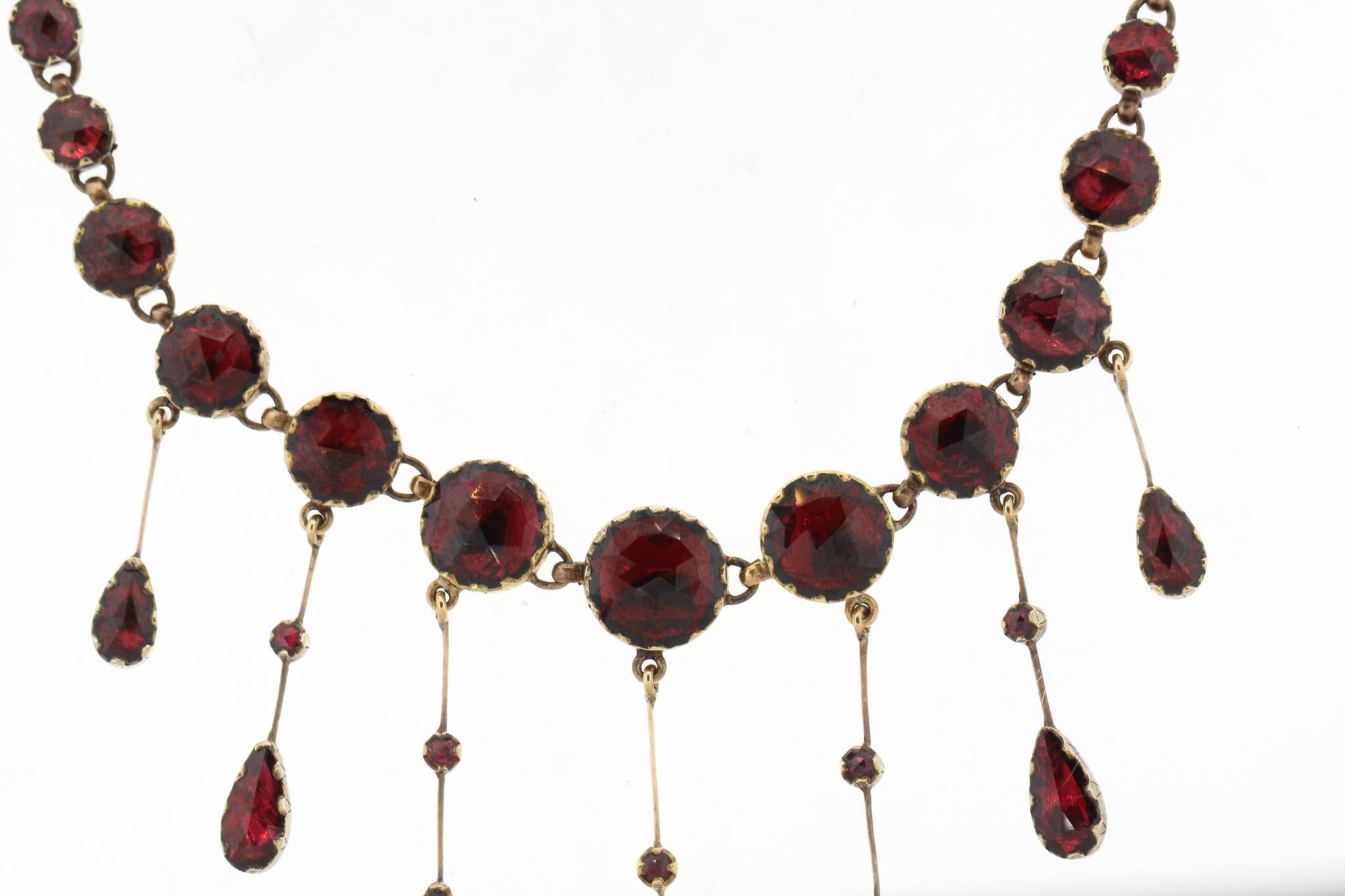 Antique 18k gold foiled back garnet necklace from the Perpignan region of France circa 1880. These fiery red garnets are cut like rose cuts, with domed tops. The unique stones are from the Northern Catalonian part of France, and the mines are now