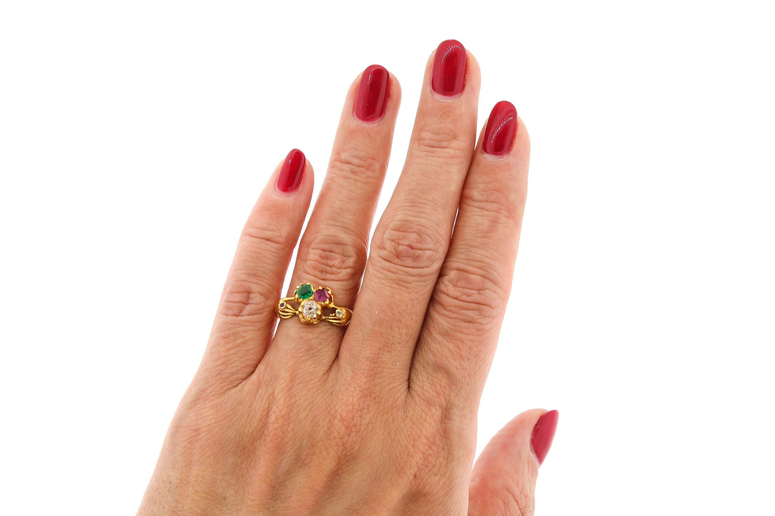 Antique 19th Century Victorian Fede ring featuring a trio of a ruby, diamond and an emerald. A Fede ring is a name for a ring featuring clasped hands symbolizing love, friendship or betrothal. Such a design goes back to Roman times. The Irish calls
