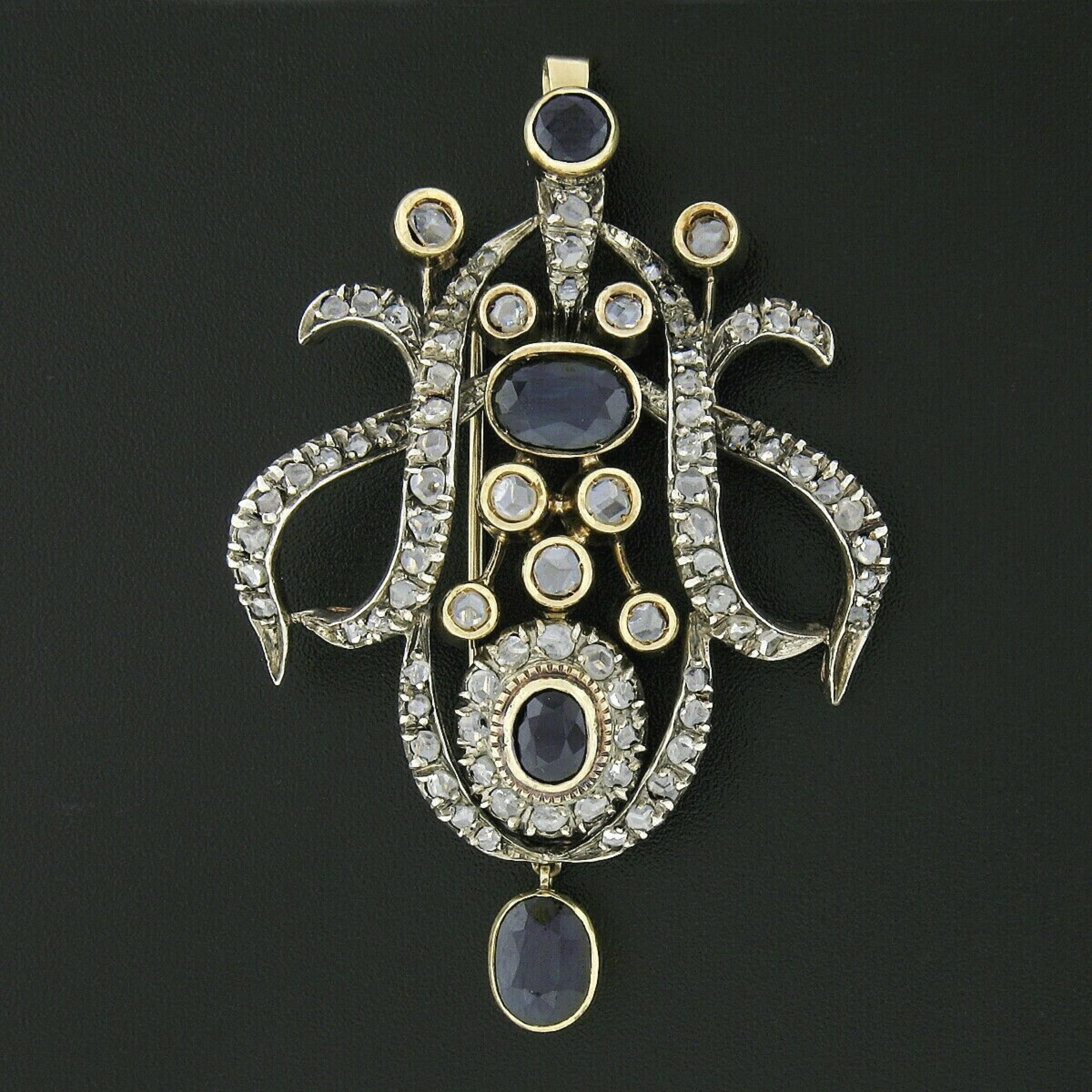 Here we have an absolutely breathtaking antique brooch or pendant that was crafted from solid 18k yellow gold and silver during the early Victorian era. It features magnificent and truly elegant, large, open design that is completely drenched with