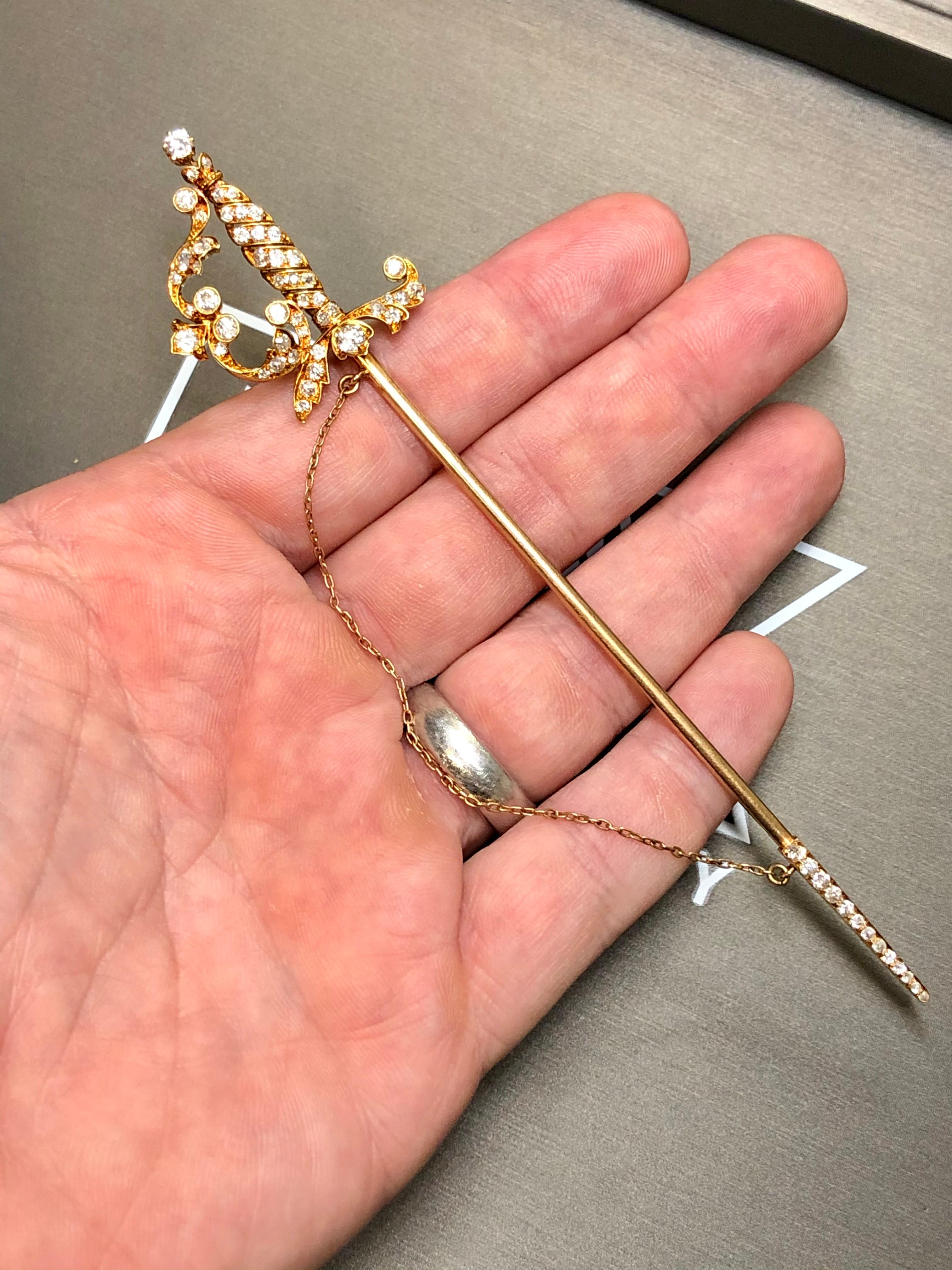 A Victorian saber jabot done in 18K (pin portion is 14k for rigidity) set with approximately 2.30cttw in G-J color Vs1-Si1 clarity original old mine cut diamonds.


Dimensions/Weight:

Jabot measures 5.6” long and weighs 14.4g.


Condition:

All