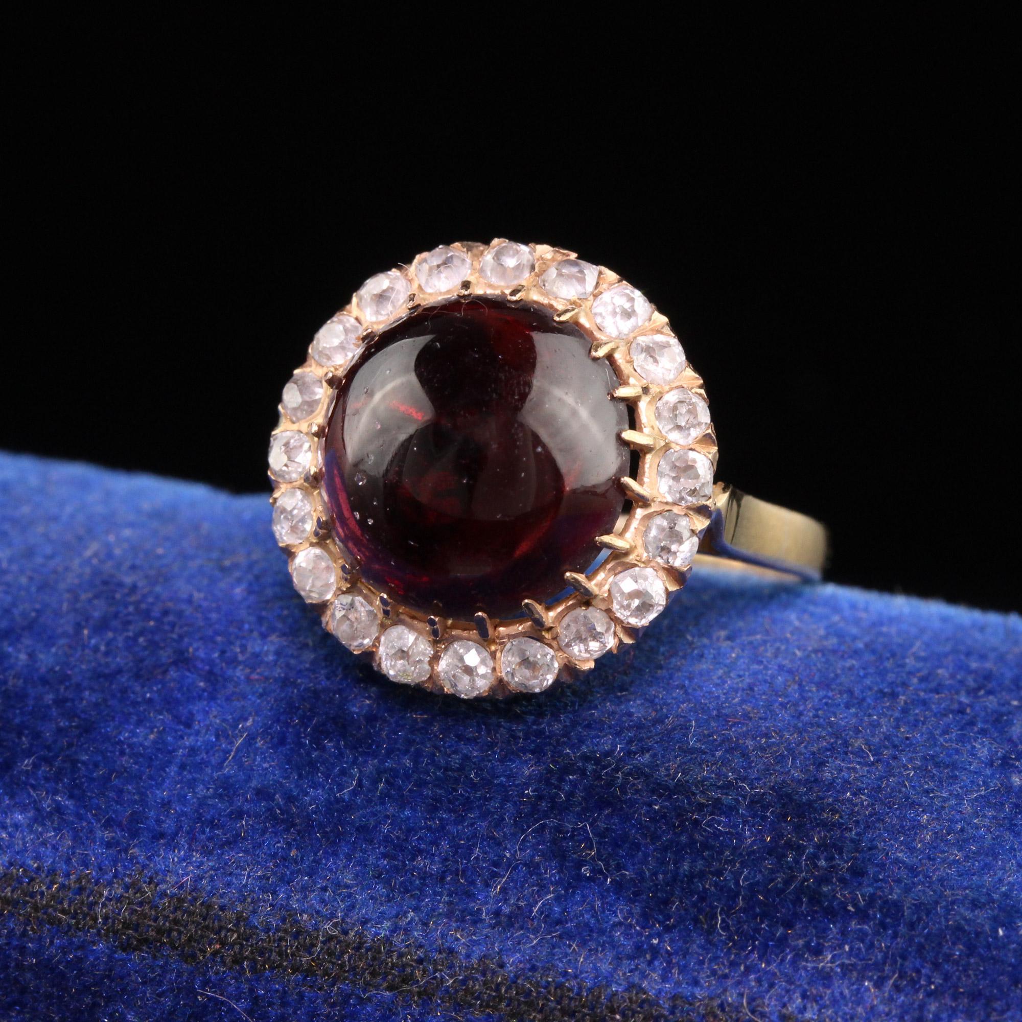 Beautiful Antique Victorian 18K Rose Gold Cabochon Garnet Old Mine Diamond Ring. This gorgeous ring is crafted in 18k rose gold. The center holds a large purple cabochon garnet and it is surrounded by old mine cut diamonds. The ring has a beautiful