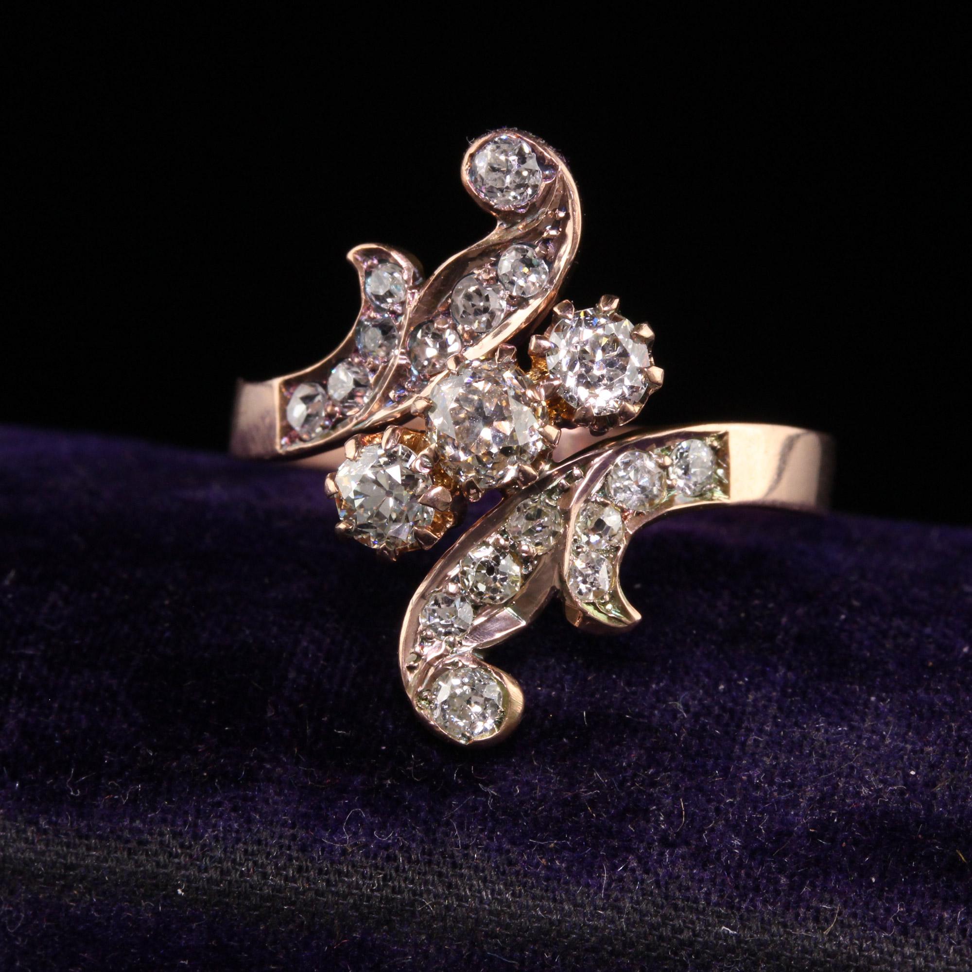 Beautiful Antique Victorian 18K Rose Gold Old Mine Cut Diamond Floral Ring. This beautiful ring is crafted in 18k rose gold. This beautiful ring has old mine cut diamonds set in the floral pattern. The ring is in great condition and sits low on the