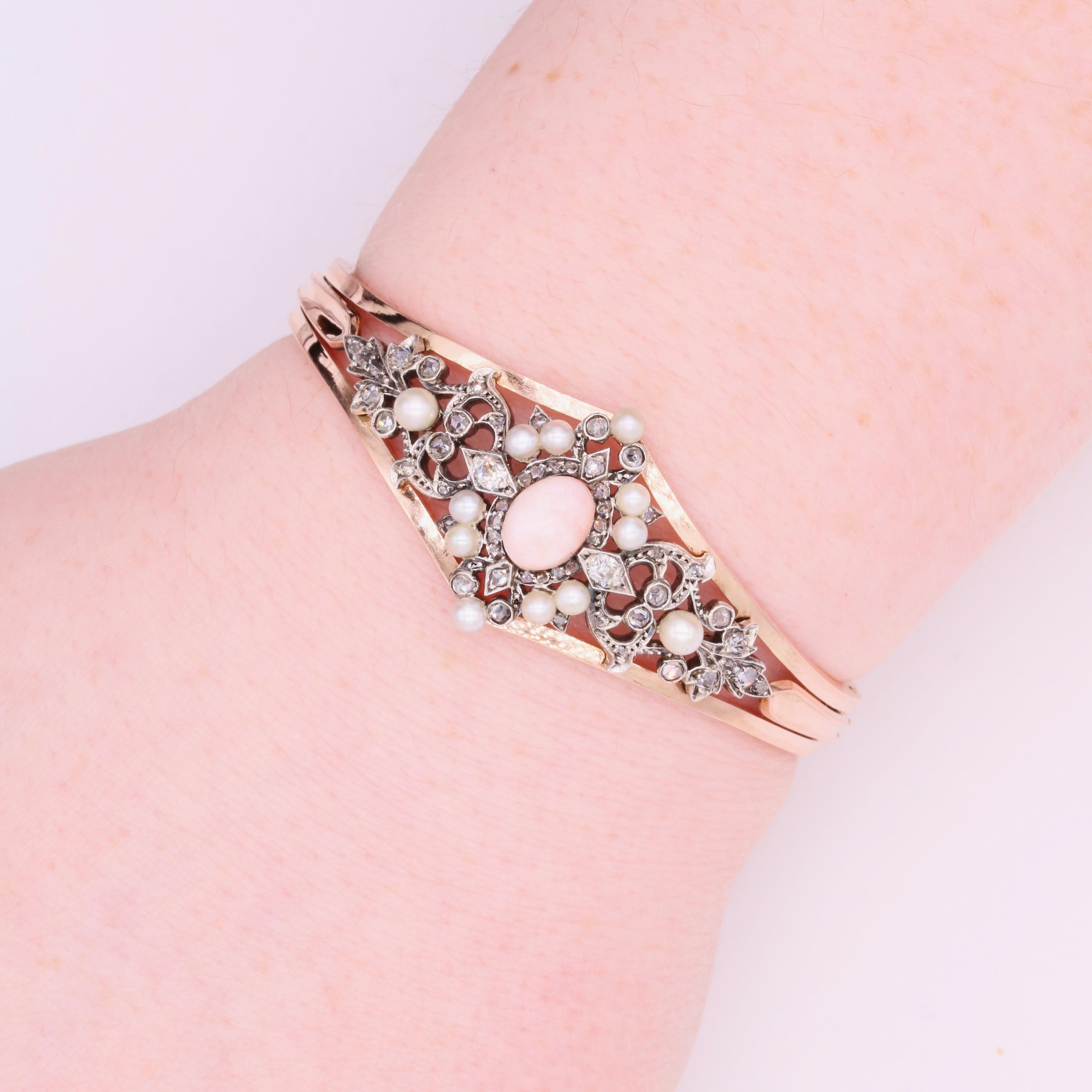 An antique rose gold, conch pearl, diamond, and pearl bracelet, comprising one oval pink conch pearl, ten seed pearls, two old mine cut diamonds, and fifty-four rose cut diamonds, set in silver, with the bracelet in 18 karat rose gold.  

The