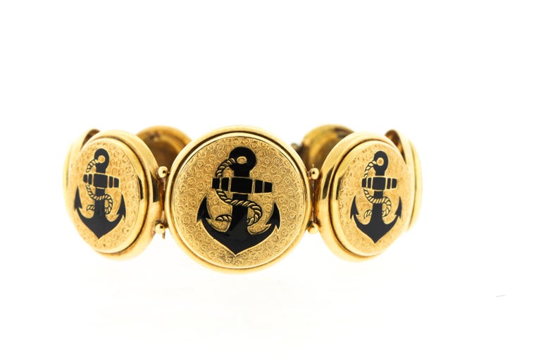 An Antique late nineteenth century tracery enamel bracelet comprised of graduating disks of engraved gold with a black enamel anchor circa 1890. The unusual bracelet is very wearable and has such sentimental imagery. The anchor being a symbol of