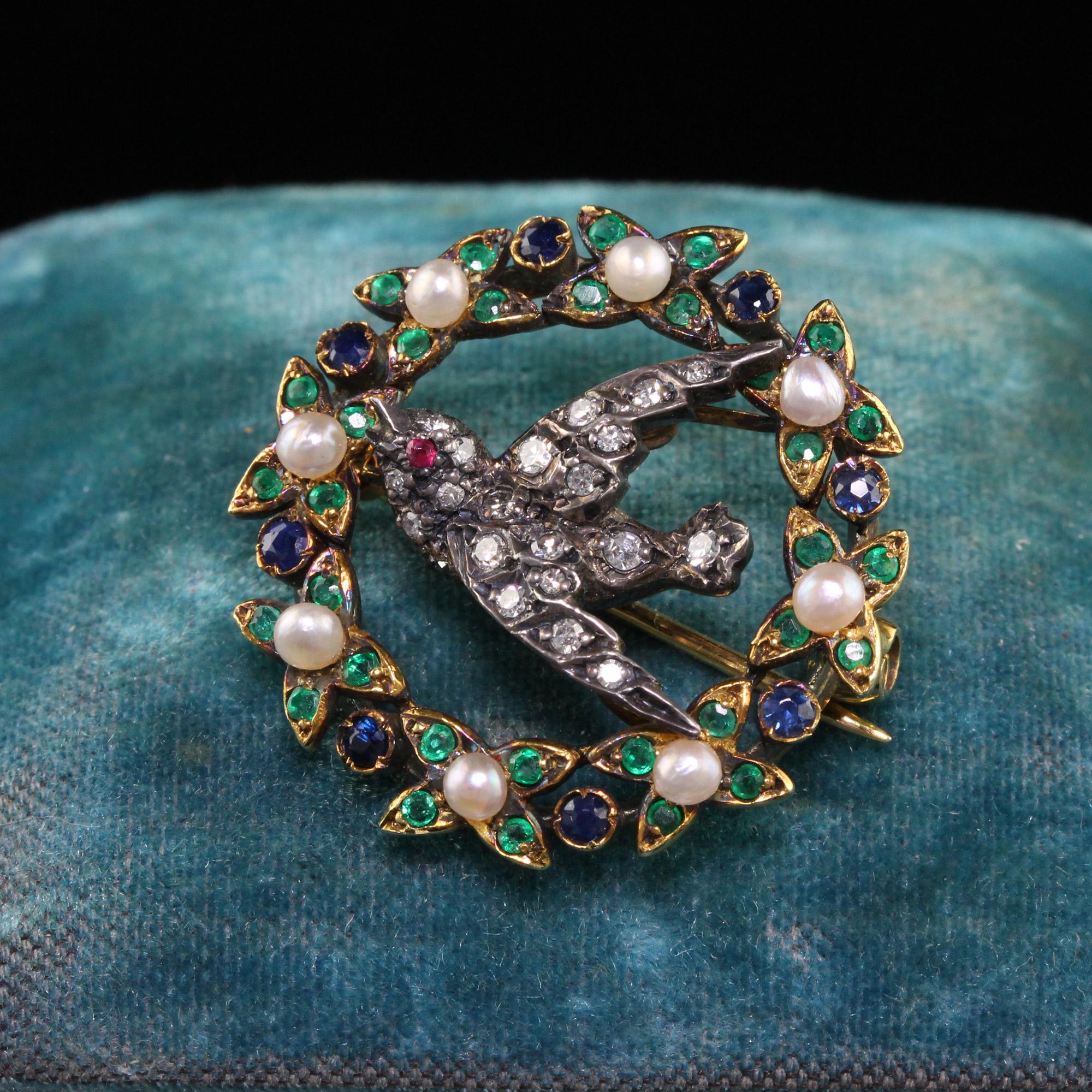 Beautiful Antique Victorian 18K Yellow Gold and Silver Topped Diamond Swallow Bird Pin. This gorgeous piece is crafted in 18k yellow gold and the swallow is silver topped. The pin has single cut diamonds, natural sapphires, emeralds and pearls on