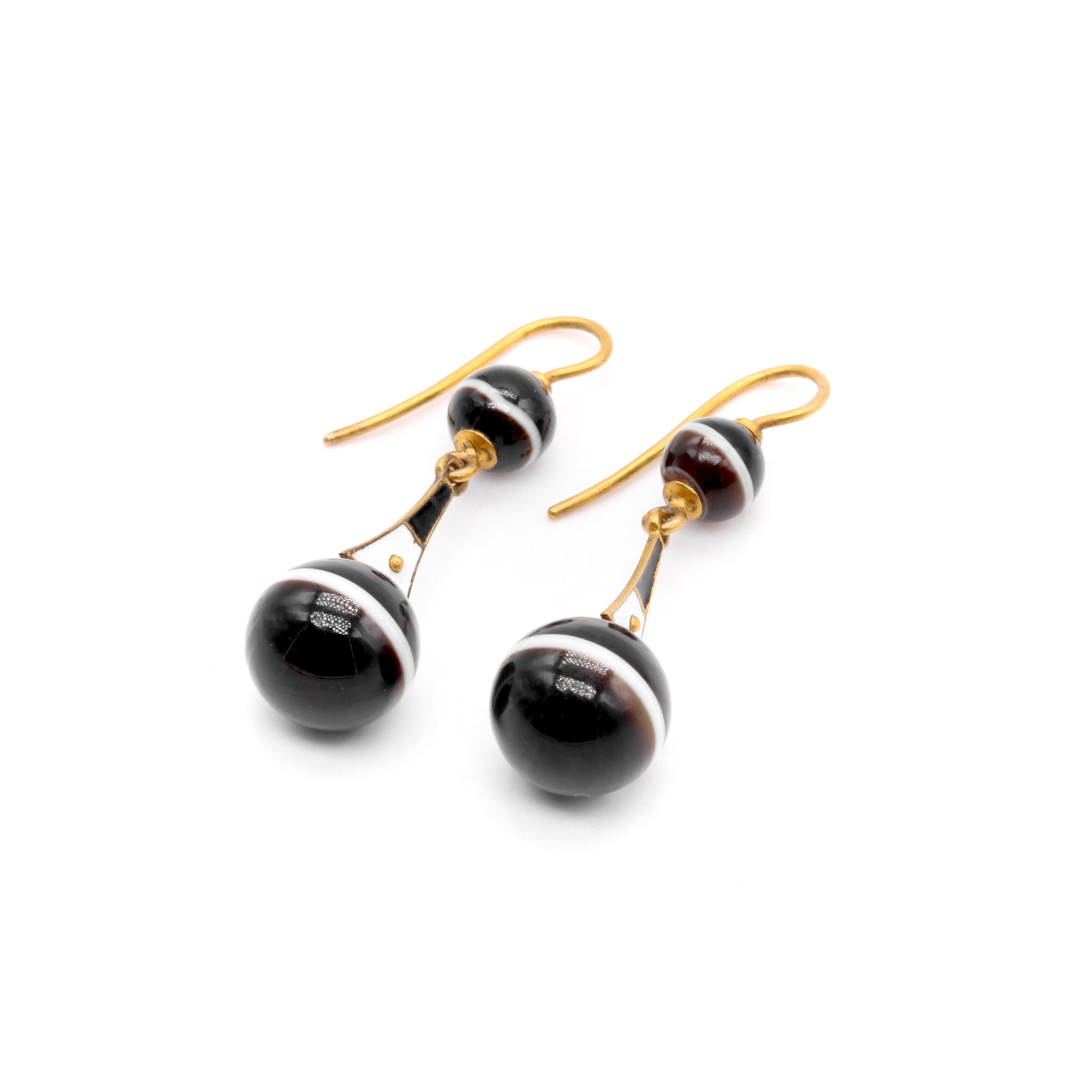 A pair of Victorian yellow gold, banded agate, and enamel earrings, each comprising two spheres of banded agate, and a panel of black and white enamel, in 18 karat yellow gold, with 18 karat yellow gold ear hooks. 

My favourite thing about these