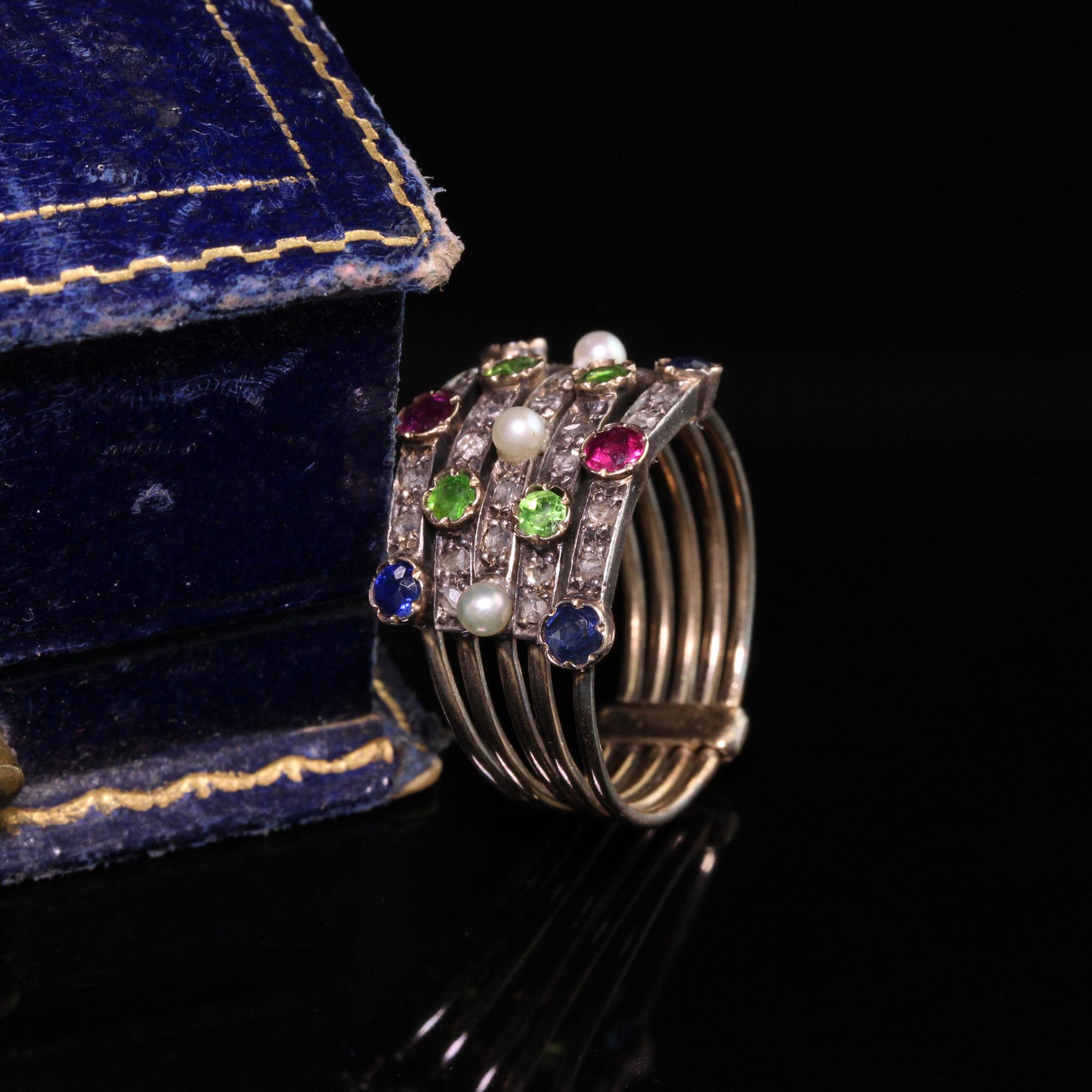 Beautiful Antique Victorian 18K Yellow Gold Diamond Sapphire Ruby Demantoid Harem Ring. This gorgeous harem ring is in great condition and has a very nice patina on the gold darkening it. It features rose cut diamonds, rubies, sapphires, pearls, and