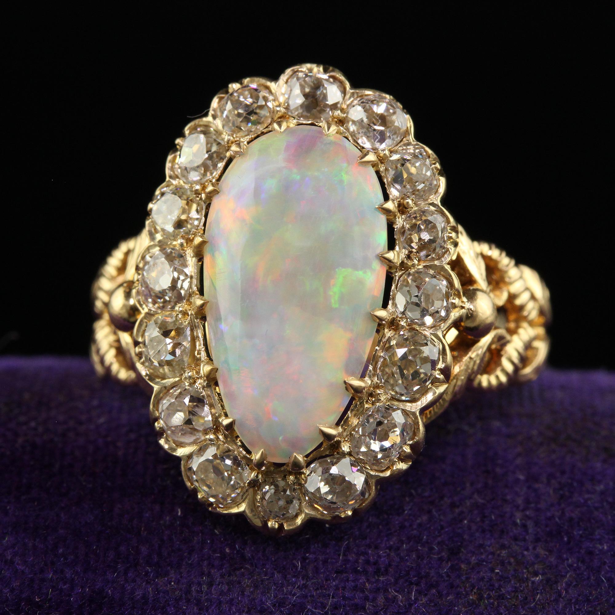 Beautiful Antique Victorian 18K Yellow Gold Natural Australian Opal Diamond Halo Ring. This gorgeous Victorian Australian opal diamond ring is crafted in 18k yellow gold. This ring features a gorgeous natural Australian opal in the center that has
