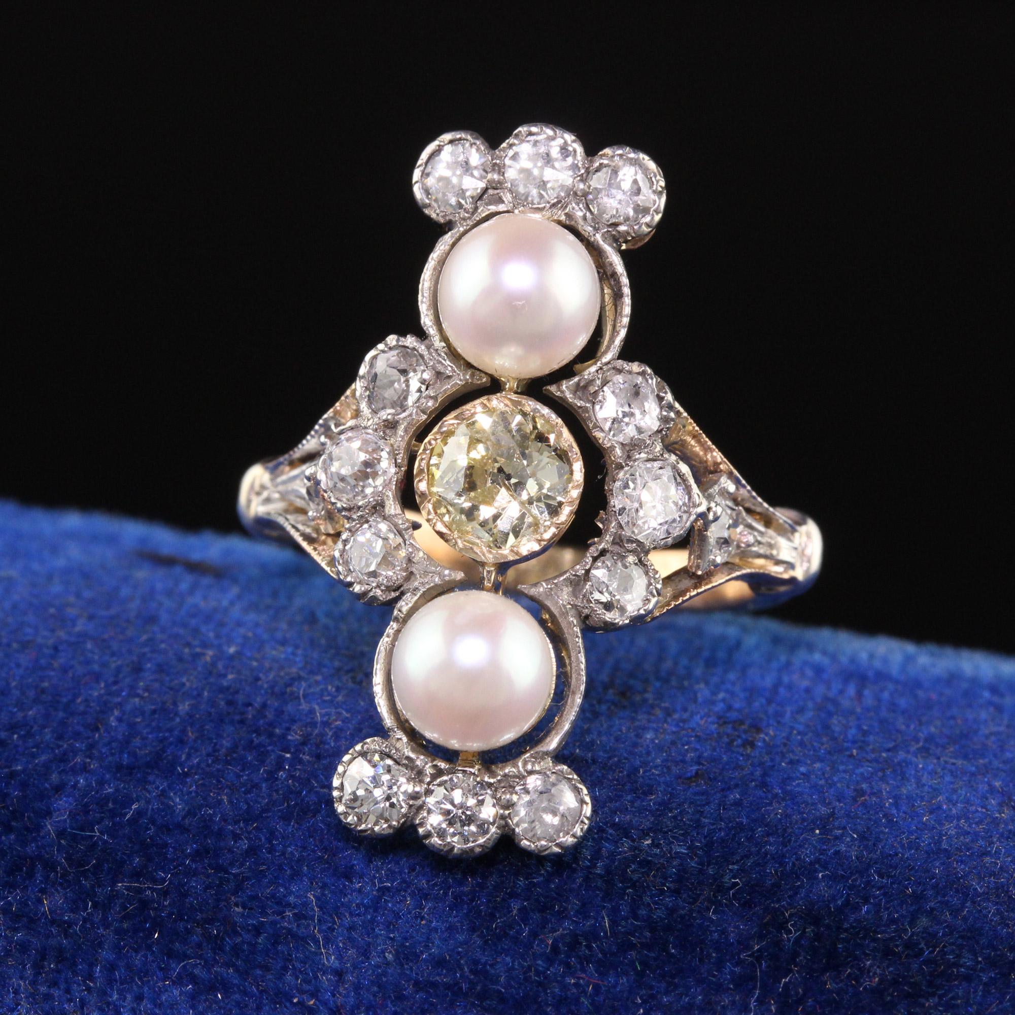 Beautiful Antique Victorian 18K Yellow Gold Old European Diamond and Pearl Shield Ring. This gorgeous ring is crafted in 18k yellow gold and silver top. There are old european cut diamonds set on the ring with a yellow old european cut in the