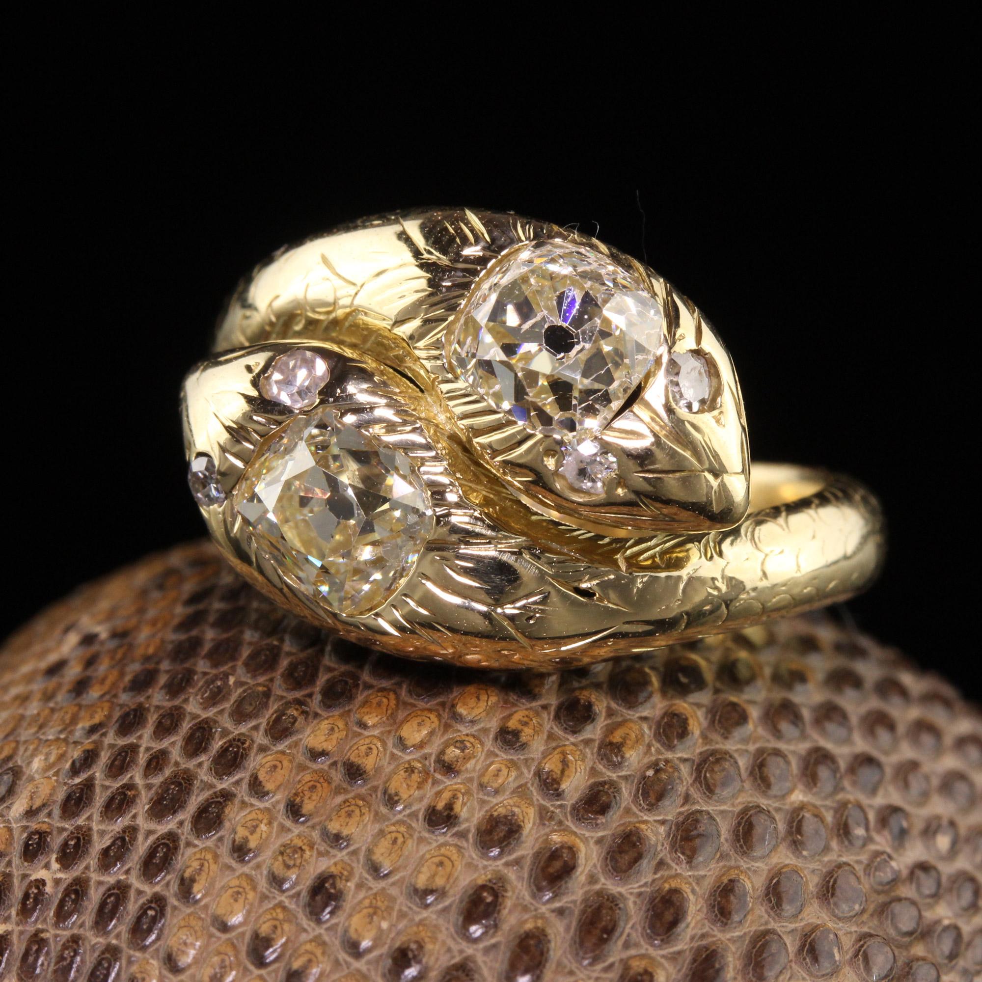 Beautiful Antique Victorian 18K Yellow Gold Old Mine Cut Diamond Double Snake Ring. This gorgeous ring is crafted in 18k yellow gold. The snake heads feature two large and chunky old mine cut diamonds with single cut diamonds for the eyes. The ring