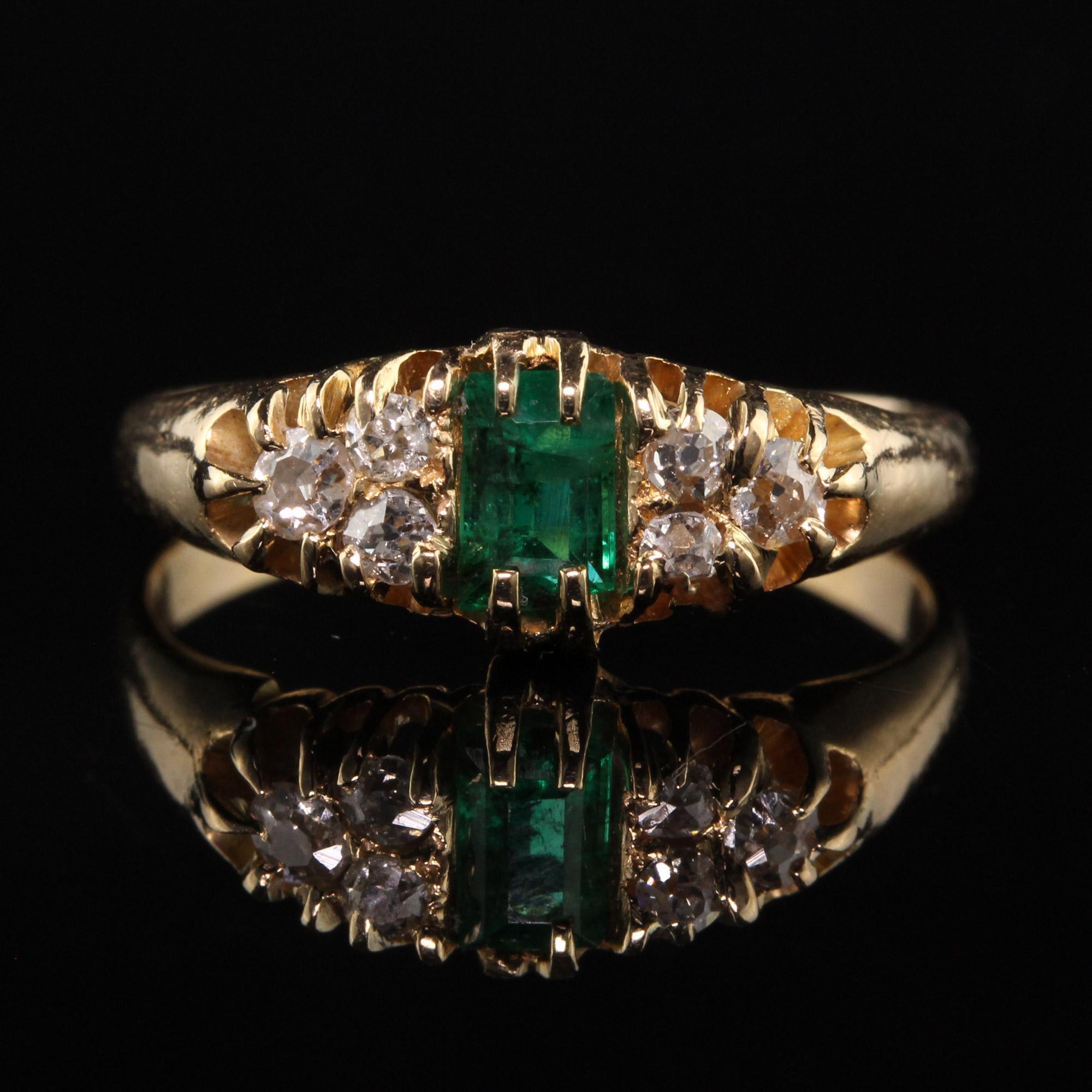 Beautiful Antique Victorian 18K Yellow Gold Old Mine Diamond and Emerald Ring. This beautiful ring is crafted in 18K yellow gold. It features an emerald in the center with 3 old mine cut diamonds on each side. The center emerald has a tiny chip on