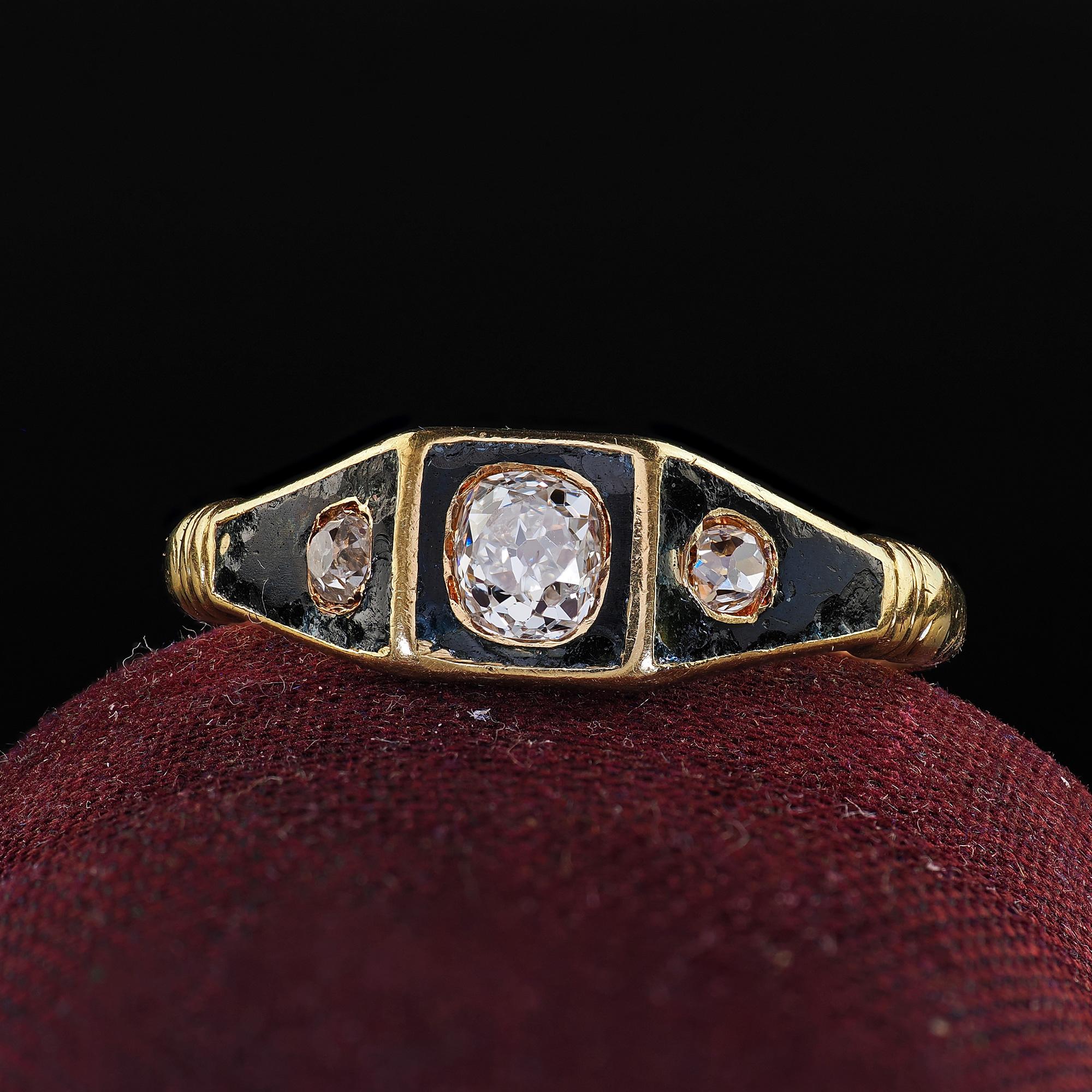 Beautiful Antique Victorian 18K Yellow Gold Old Mine Diamond Enamel Three Stone Ring. This beautiful Victorian old mine diamond and enamel three stone ring is crafted in 18k yellow gold. This ring features three old mine cut diamonds set in a