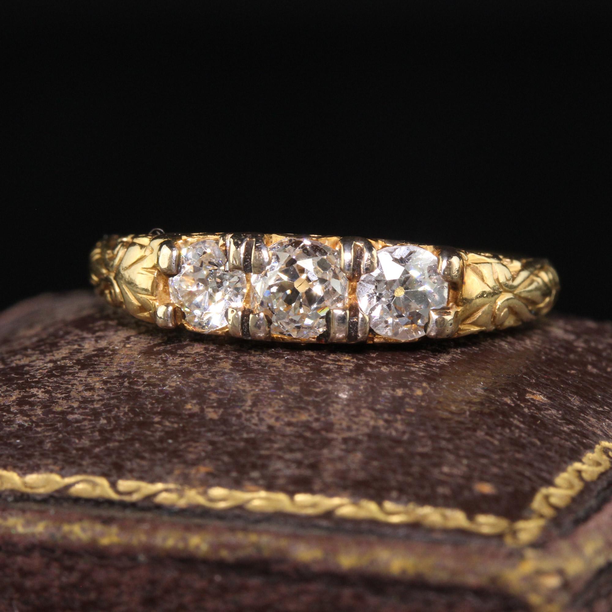 Beautiful Antique Victorian 18K Yellow Gold Old Mine Diamond Three Stone Wedding Band. This beautiful Victorian three diamond wedding band is crafted in 18k yellow gold. The center holds three chunky old mine cut diamonds that have a beautiful