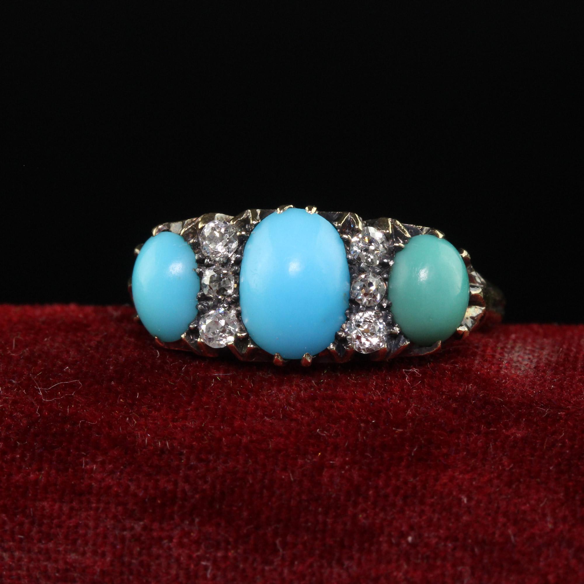 Beautiful Antique Victorian 18K Yellow Gold Old Mine Diamond Turquoise Three Stone Ring. This beautiful Victorian turquoise and diamond three stone ring is crafted in 18k yellow gold. The ring features beautiful blue cabochon turquoises with two