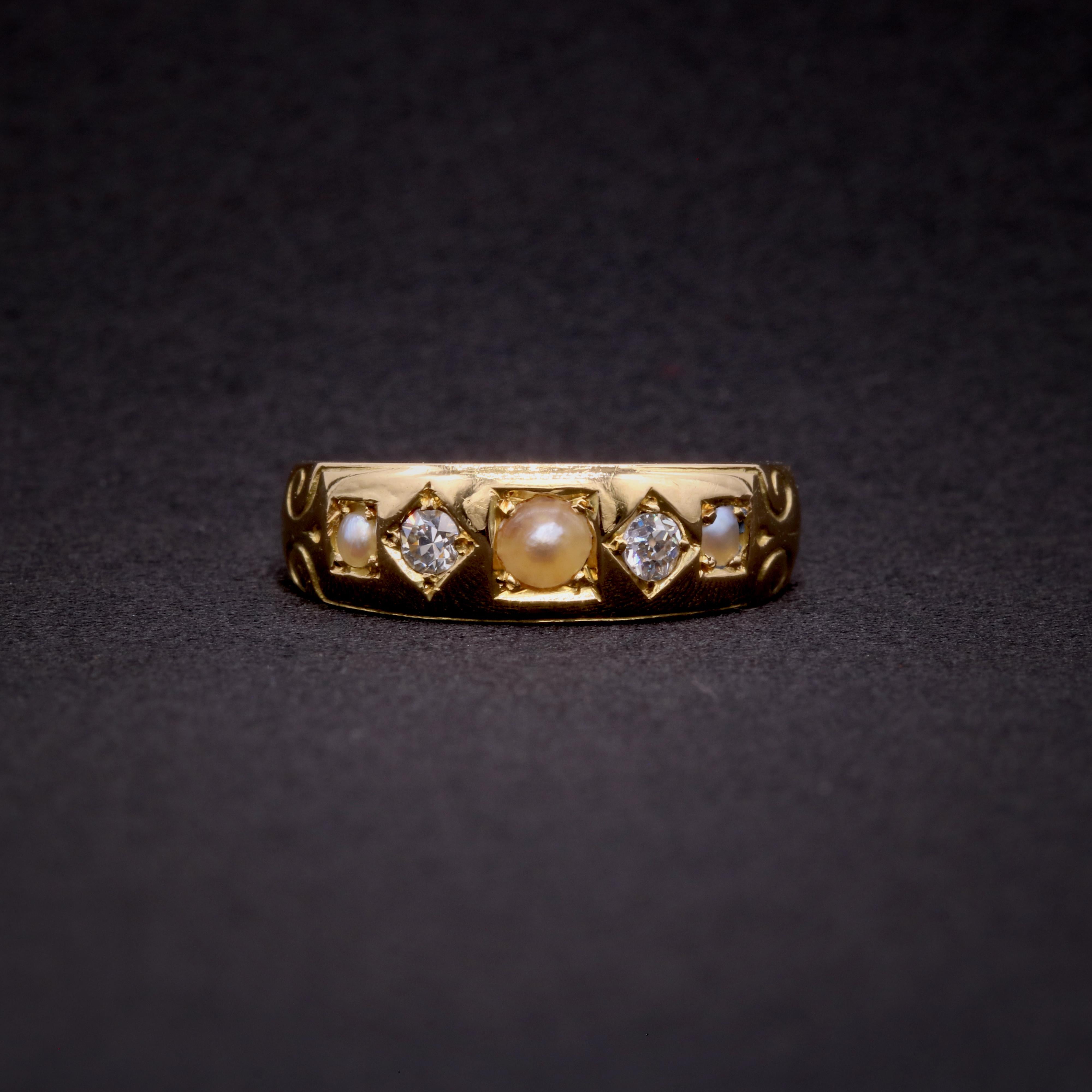 A Victorian pearl, diamond, and yellow gold ring, set with three half seed pearls, and two old single cut diamonds, set in 18 karat yellow gold, to an 18 karat yellow gold band.

This lovely Victorian ring is set to the centre with a shimmering seed