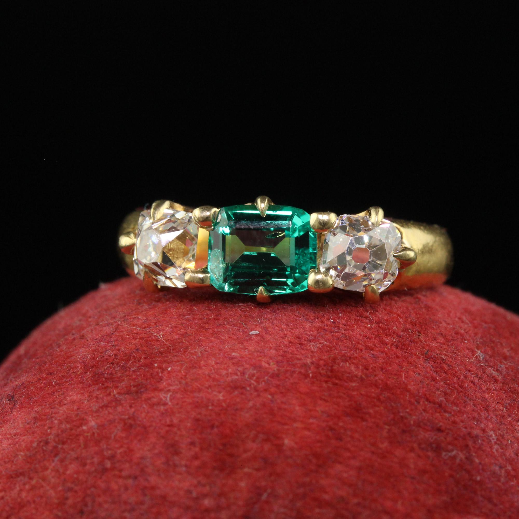 Beautiful Antique Victorian 18K Yellow Gold Peruzzi Cut Diamond Emerald Three Stone Ring. This incredible late Victorian Peruzzi diamond emerald ring is crafted in 18k yellow gold. The ring features a gorgeous green Colombian emerald in the center