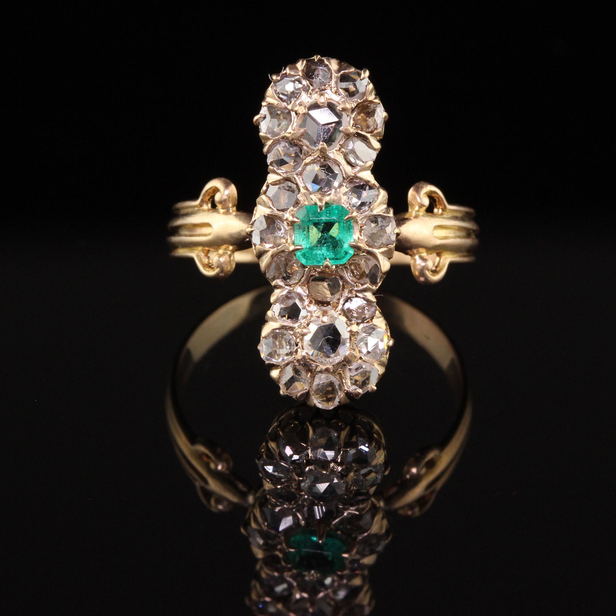 Beautiful Antique Victorian 18K Yellow Gold Rose Cut Diamond and Emerald Shield Ring. This gorgeous shield ring is crafted in 18k yellow gold. The ring has white rose cut diamonds set all over the top of the ring with a natural Colombian emerald in