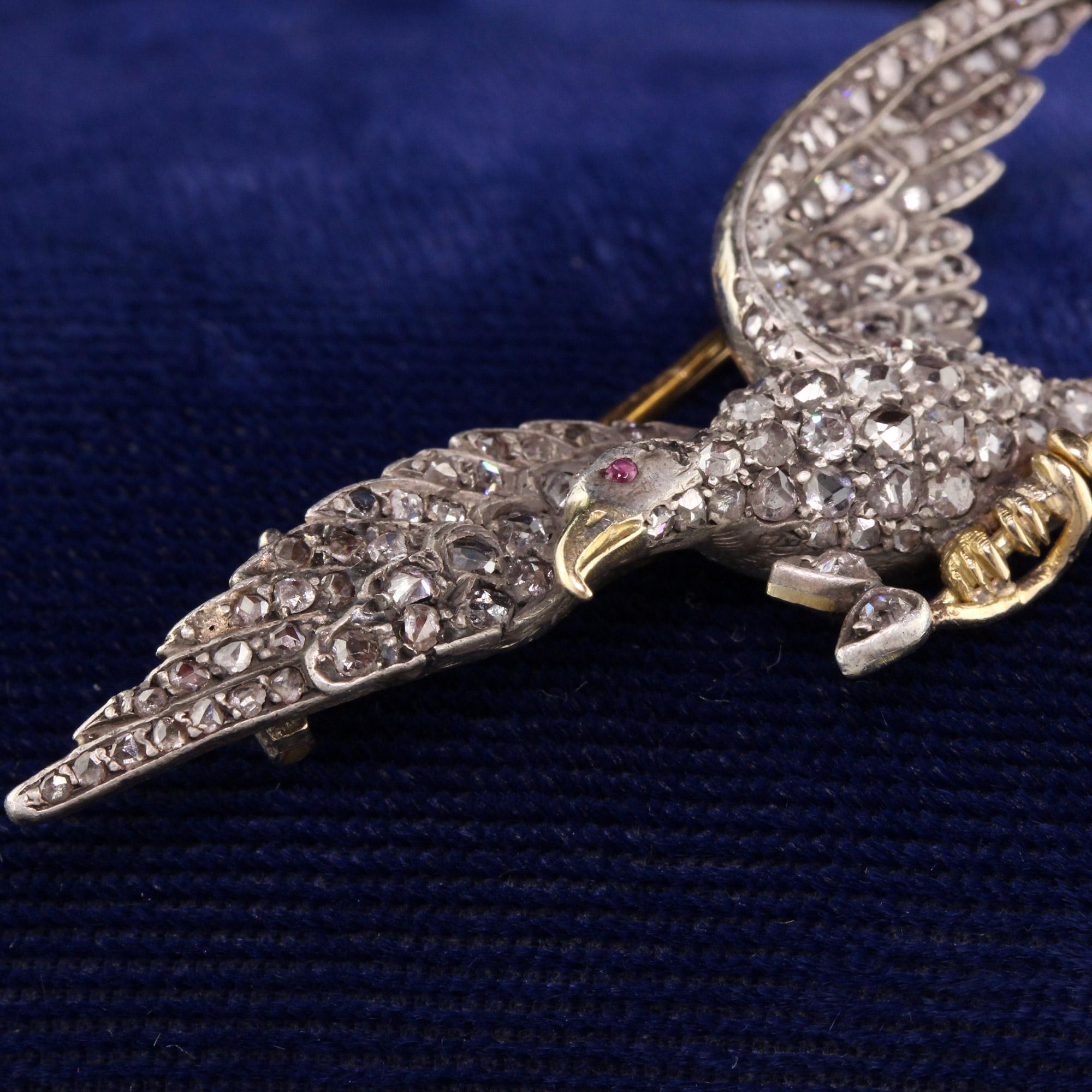 Beautiful Victorian eagle pin with rose cut diamonds and a ruby as an eye. 

Item #P0088

Metal: 18K Yellow Gold

Weight: 8.7 Grams

Total Diamond Weight: Approximately 1.00 cts

Diamond Clarity: SI2

Measurements: 2.06 in x 9.1 mm