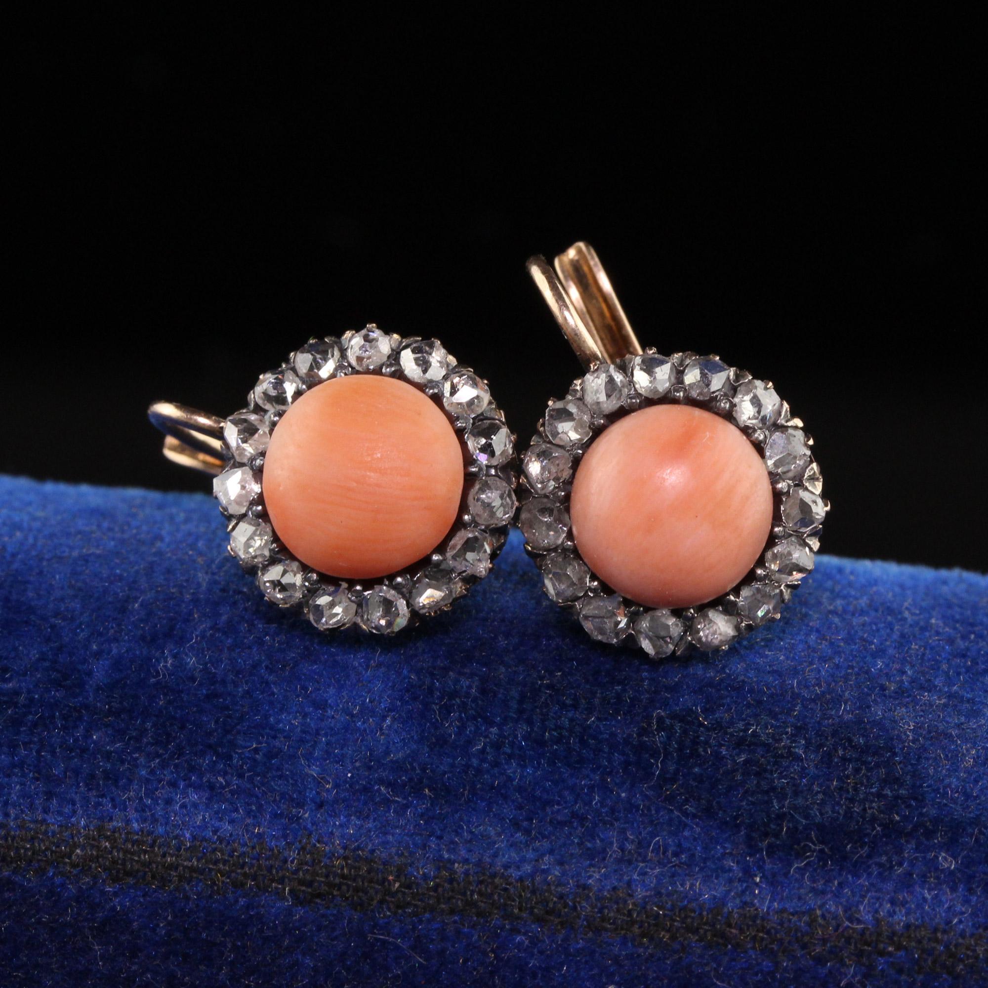 Beautiful Antique Victorian 18K Yellow Gold Rose Cut Diamond Halo Coral Drop Earrings. These gorgeous pair of earrings are crafted in 18k yellow gold. The center of the earrings hold natural corals and are surrounded by beautifully cut rose cut