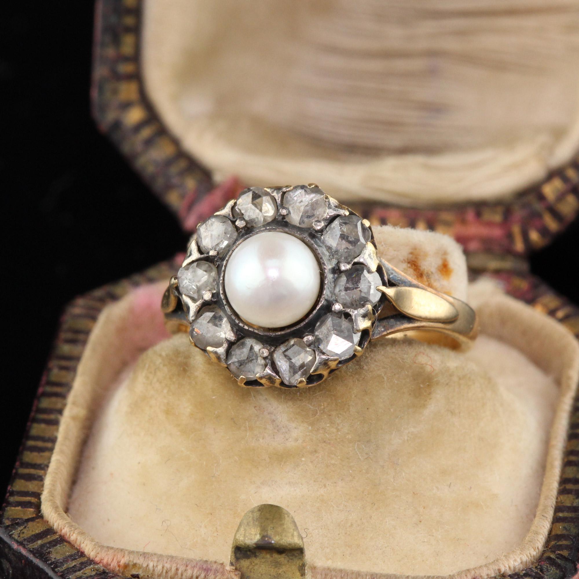 A classic Victorian cluster ring featuring a pearl in the center surrounded by a halo of rose cut diamonds.

#R0114

Metal: 18K Yellow Gold

Weight: 3.4 Grams

Total Diamond Weight: Approximately 0.50 cts

Pearl Measurements: 5.7 mm wide

Ring Size: