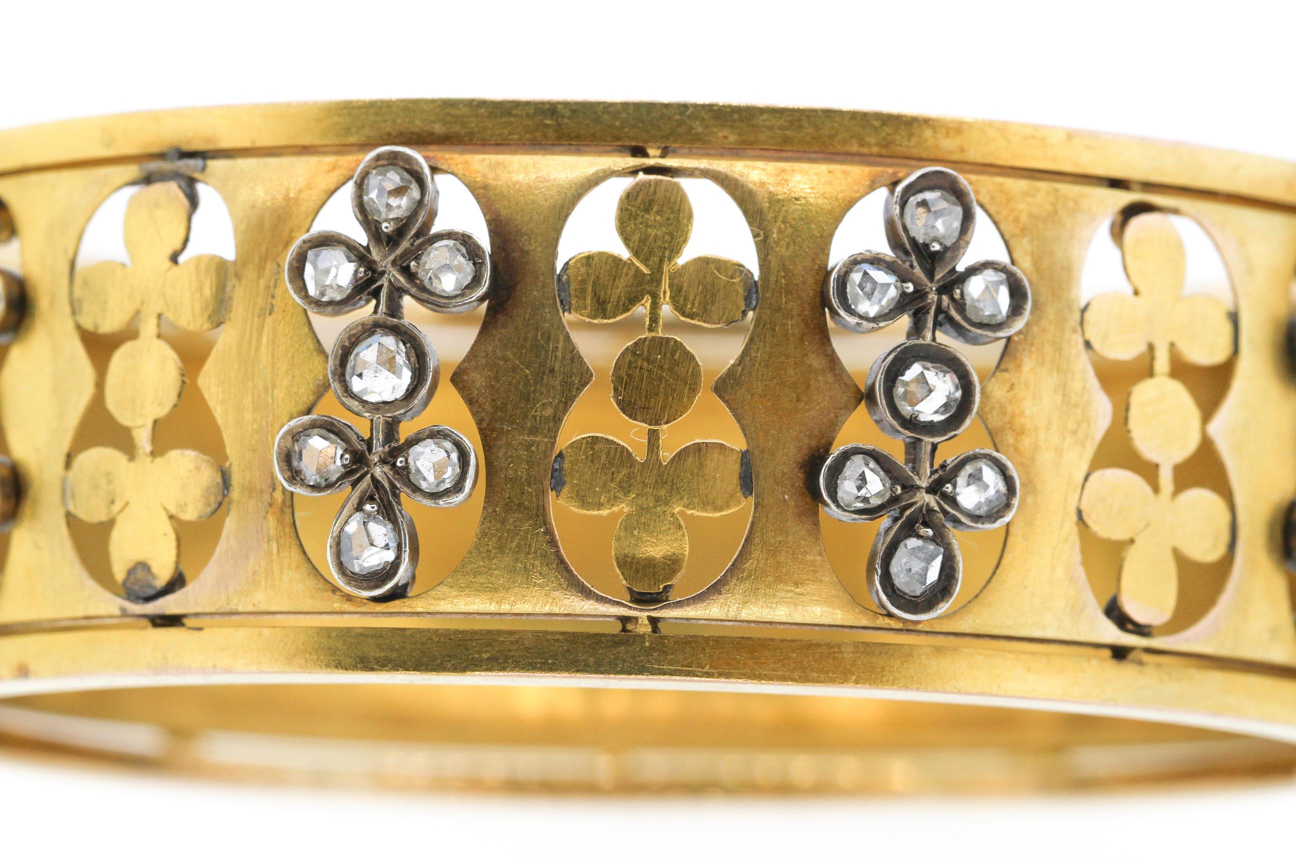A beautiful antique Victorian 18k yellow gold bracelet set with rosecut diamonds, circa 1880. The 28 rosecut diamonds are set in silver topped gold creating a contrast in colors. There are cutout clover designs alternating with the diamond design.