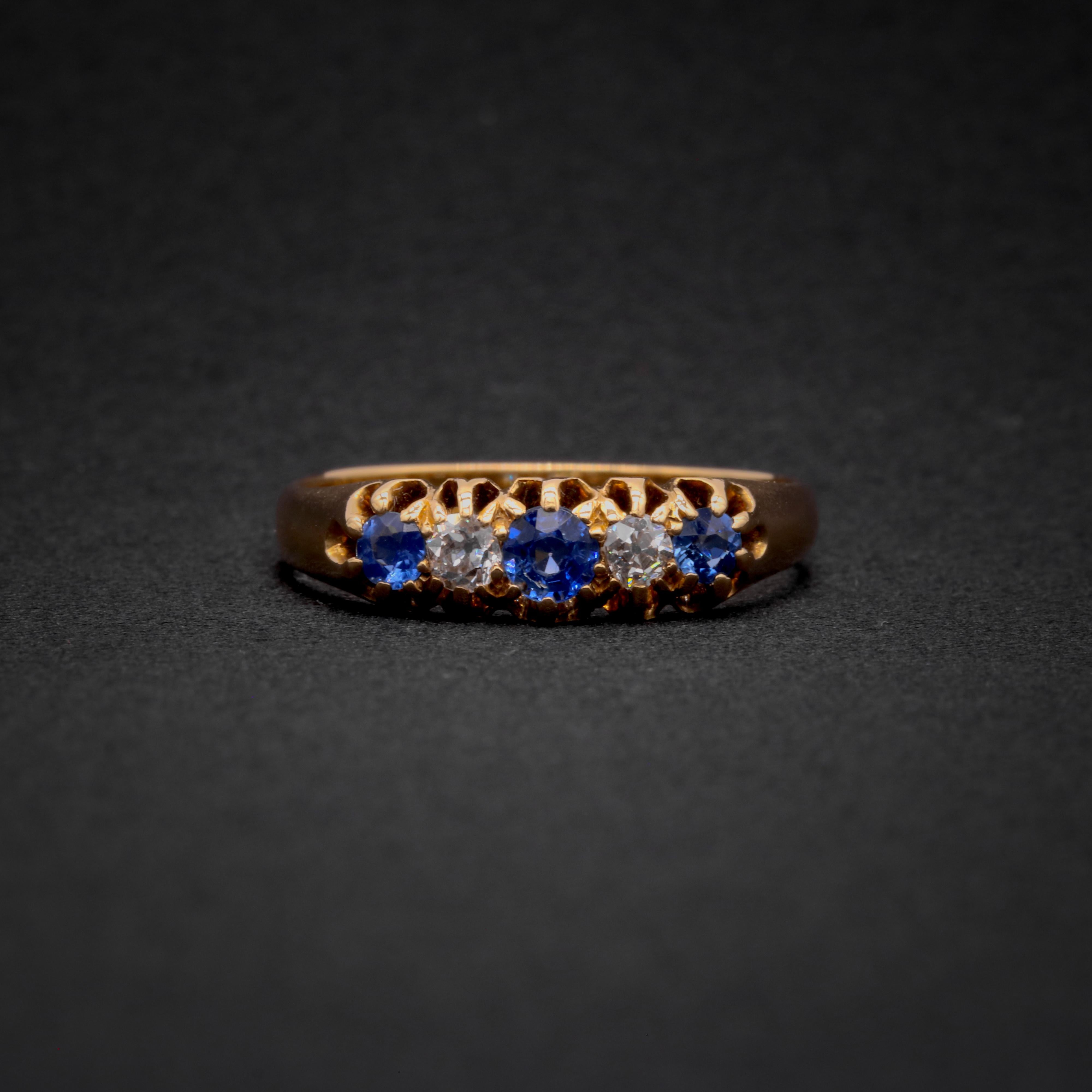 A Victorian sapphire, diamond, and yellow gold ring, comprising three round cut blue sapphires, and two old single cut diamonds, set in 18 karat yellow gold, to an 18 karat yellow gold band.

My favourite thing about this Victorian 18K Gold Sapphire