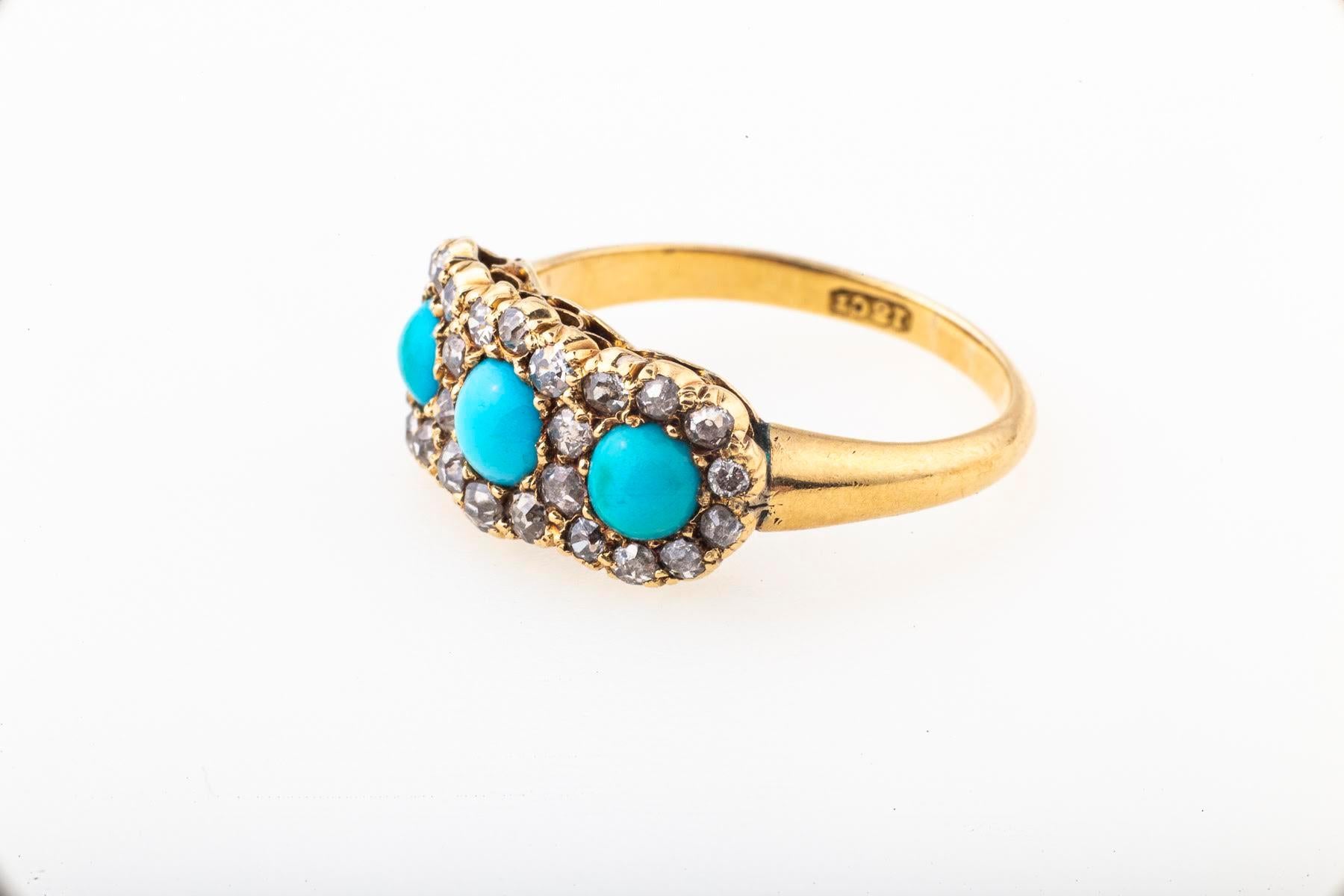A perfect Turquoise and Diamond Ring that brings sparkles of delight from the Victorian era in England. The turquoise gems are round interspersed with old european round diamonds forming three floral settings. Turquoise was a favored gem of the