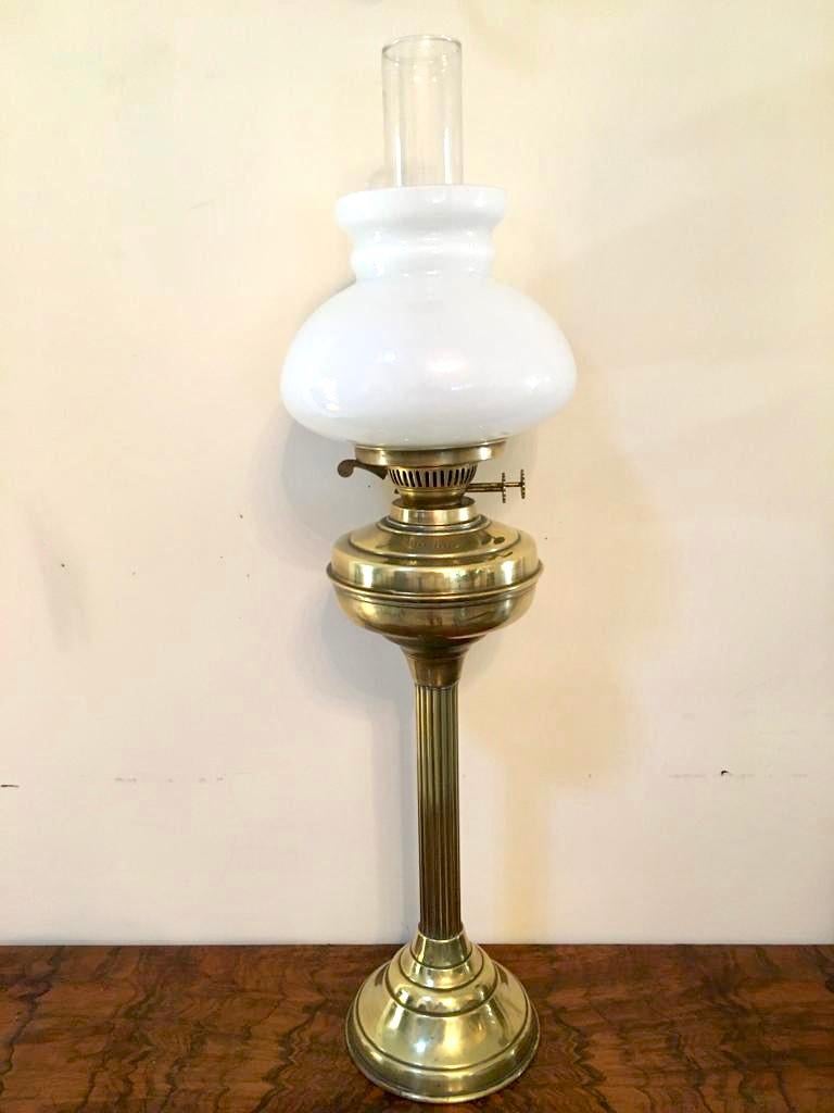 Antike viktorianische Öllampe aus Messing aus dem 19. Jahrhundert mit dem originalen weißen Glasschirm und Schornstein. Er verfügt über einen Doppelbrenner, eine Messingfront mit geriffelter Messingsäule und steht auf einem runden