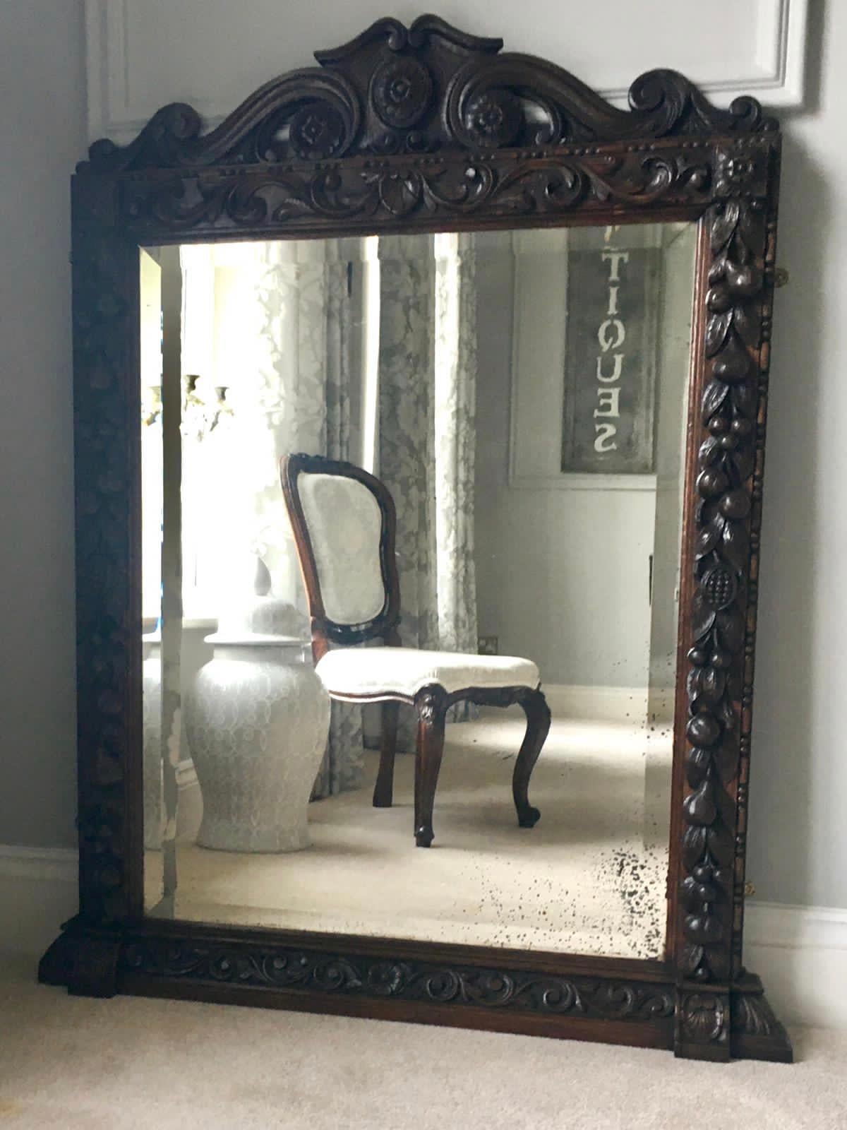 Antique Victorian 19th century carved oak free standing mirror having a fabulous quality shaped carved pediment and heavily carved oak surround which depicts a mix of pears, acorns, figs and leaves. It boasts the original bevel edged mirror and it