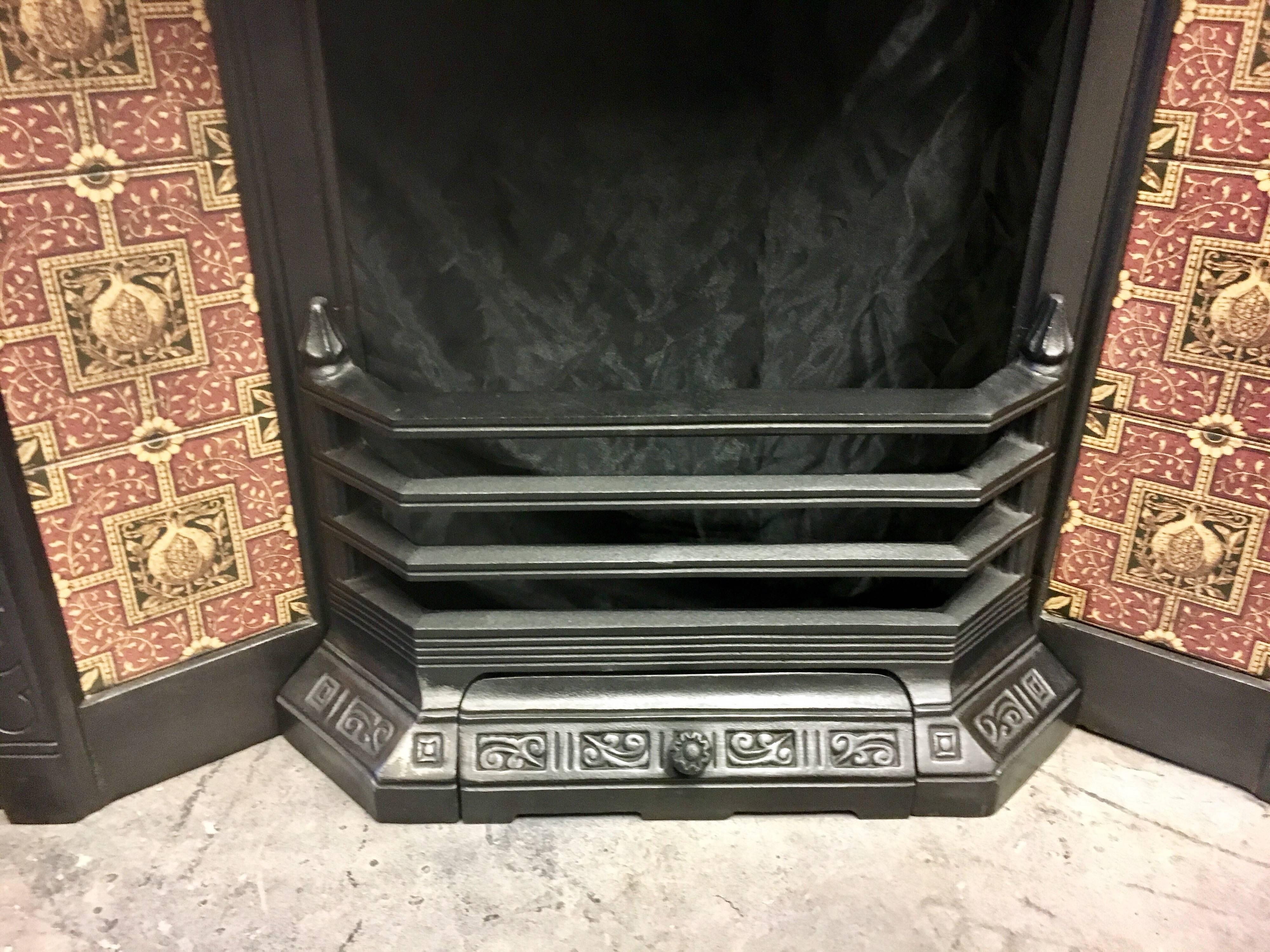 An antique Victorian 19th century cast iron tiled fireplace insert, a central Patrea to the hood with a well cast frame border holding red/yellow hand-painted tiles.

Scottish, circa 1890.
