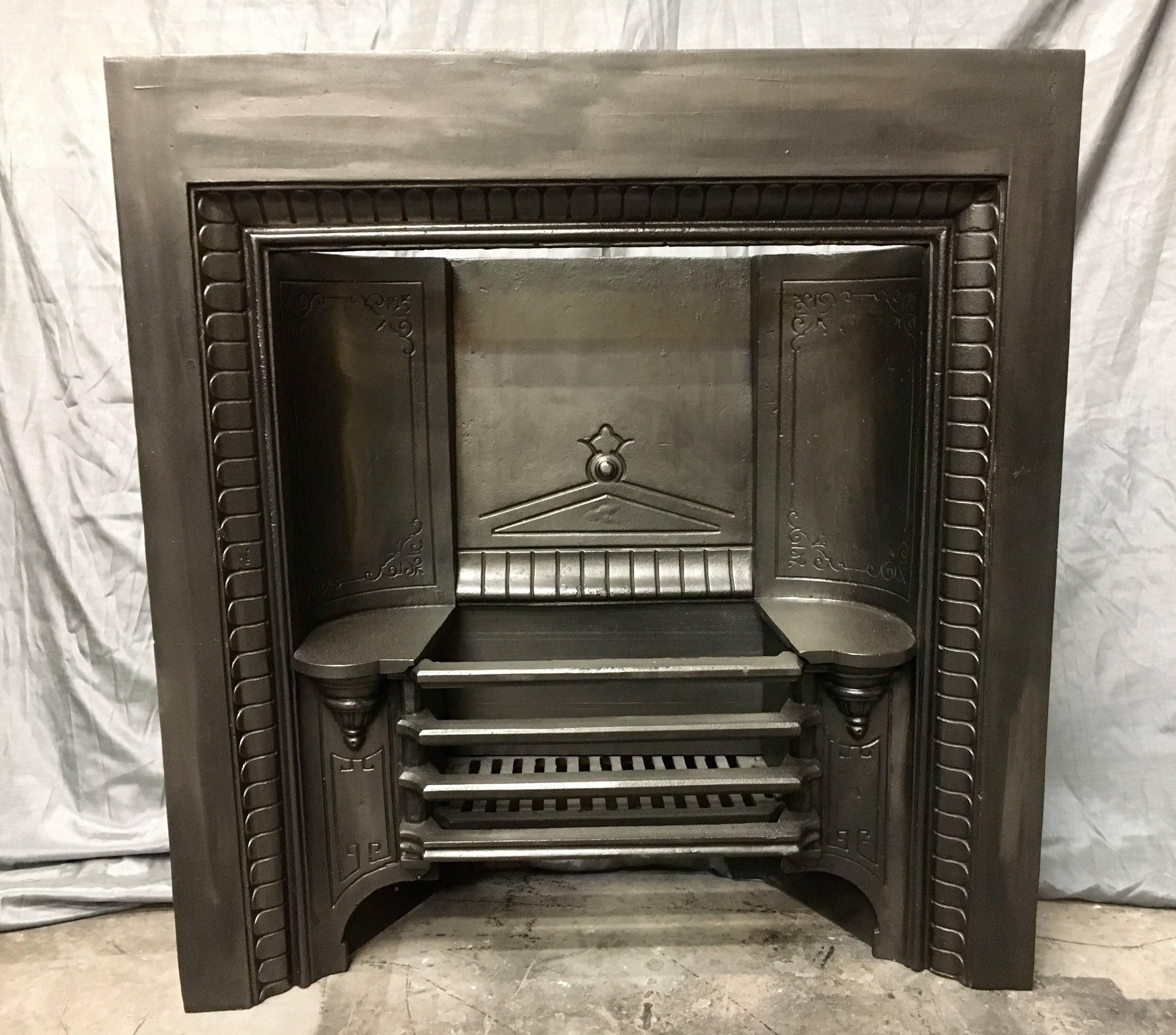 Antique Victorian 19th century hob grate fireplace insert, cast by the famous Coalbrookedale foundry. A stylized repeating leaf border with convex back panels to the back, supported by tapered turned supporting brackets- a grate of four bars sits