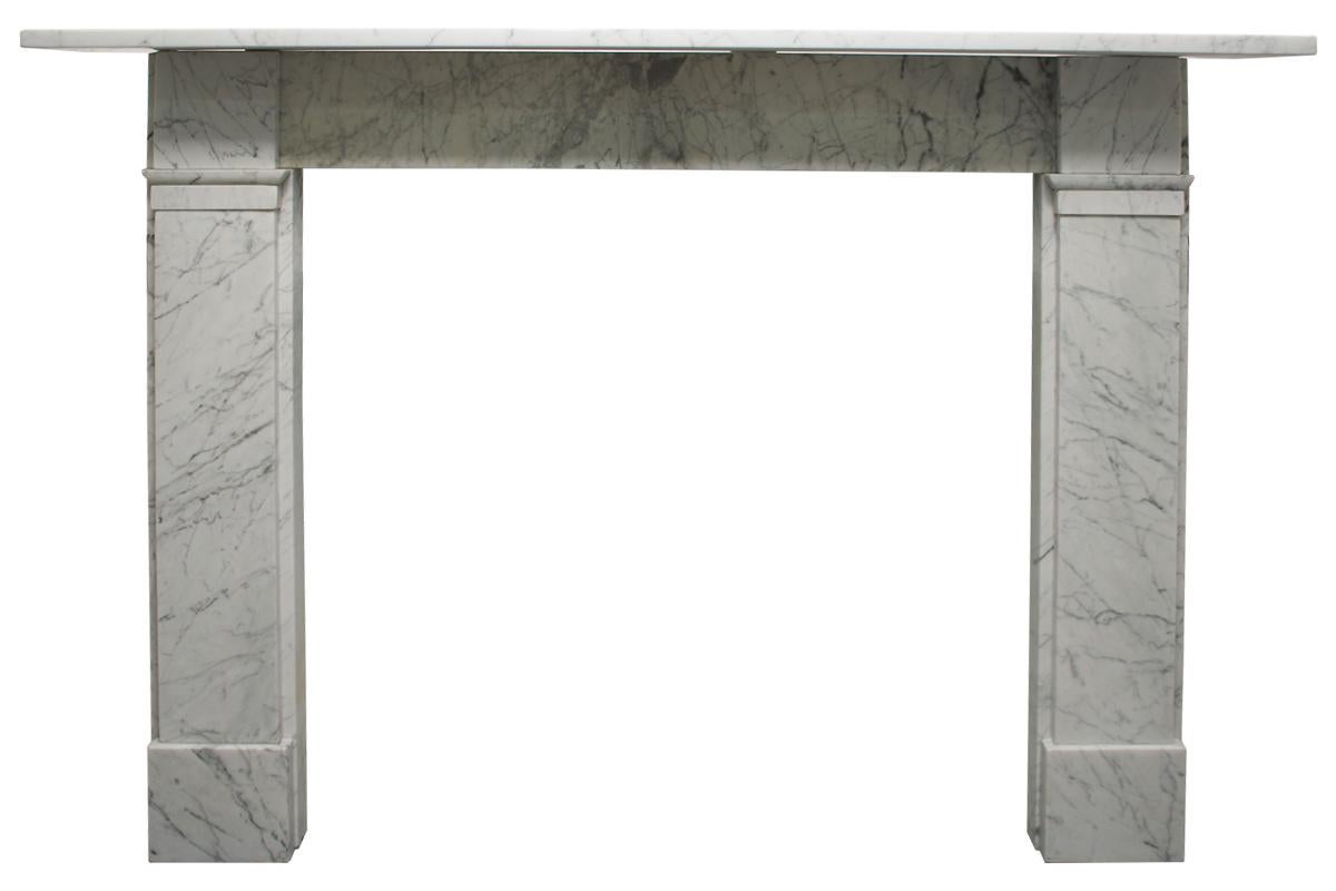 An antique late 19th century Victorian fireplace surround in carrara marble of simple unadorned form. Square capitals above plain jambs and foot blocks.

Aperture width is adjustable between 900-950mm / 35.5