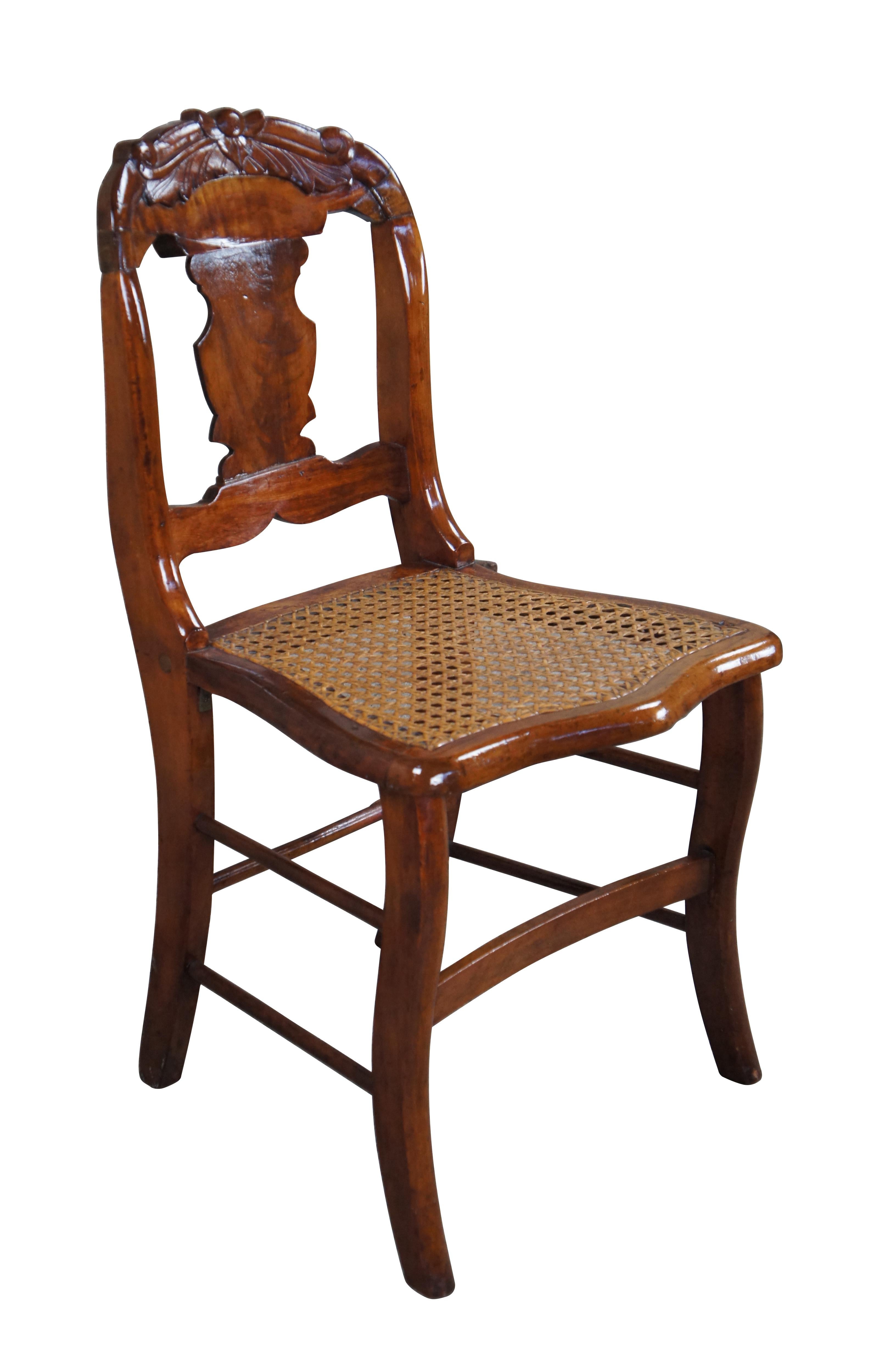 Antique Victorian 19th Century dining side or desk chair.  Made of walnut featuring slat back with carved accents and caned seat.

Dimensions:
17.5