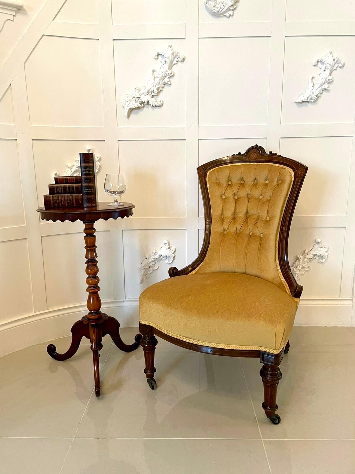 Antique Victorian 19th century walnut inlaid ladies chair having a delightful shaped inlaid back and standing on elegant shaped turned tapering legs to the front, outswept to the back with original castors. Newly re-upholstered in a quality fabric