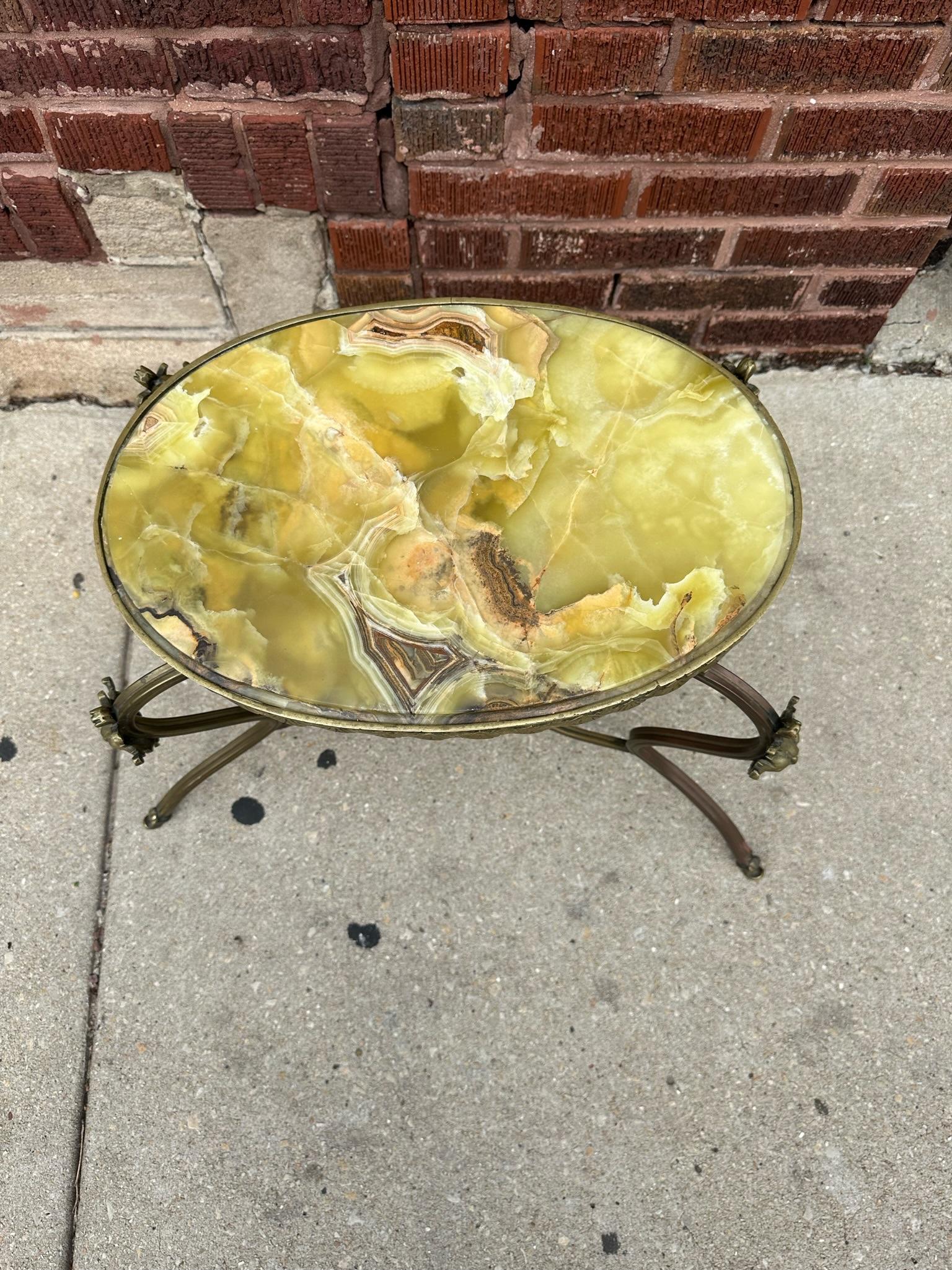 Antique Victorian 2 Tier Ornate Onyx and Brass Figural Devil Heads Side Table 

Beautiful Beveled Edge Oval Green Onyx with Intricate Detailed Ornate Brass Frame with 4 Figural Devil Heads Side Table. 

Perfect Addition Of Old Hollywood Glam to Your