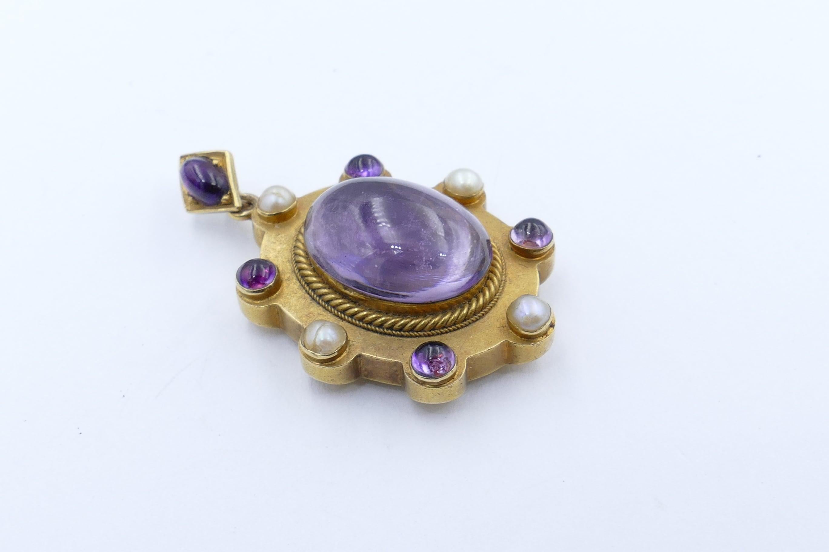 The Centrepiece of this very unusual & beautiful Victorian Pendant/Locket is a 23.04 carat Amethyst of a somewhat translucent lightish purple, clarity eye-clean, oval cabochon cut, bezel set.
As well there are a further 4 round/oval cut Amethysts